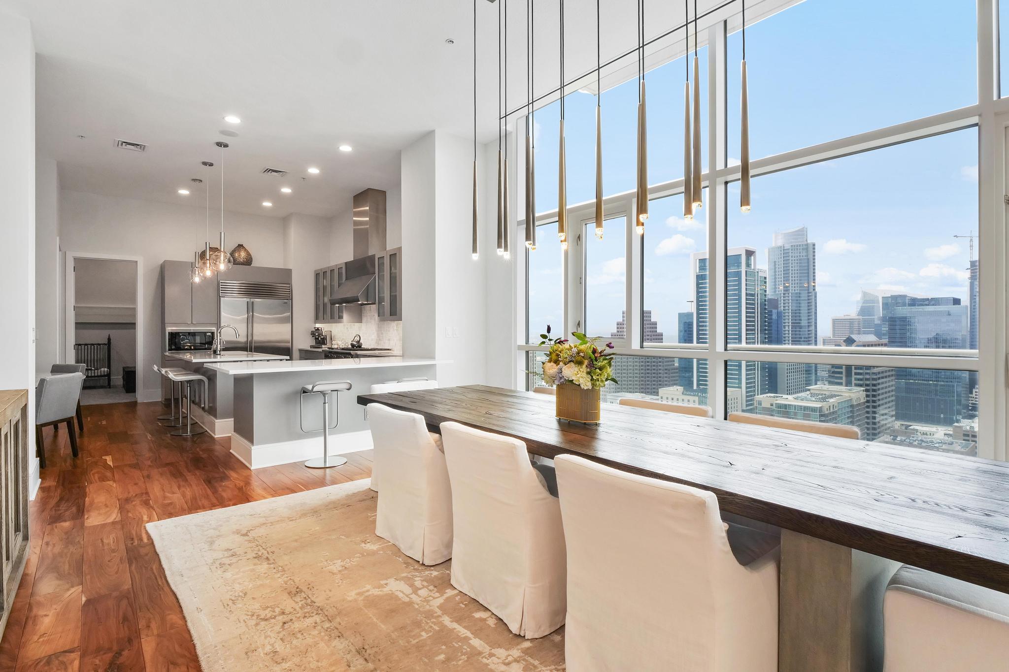 Floor-to-ceiling windows showcase dynamic city vi