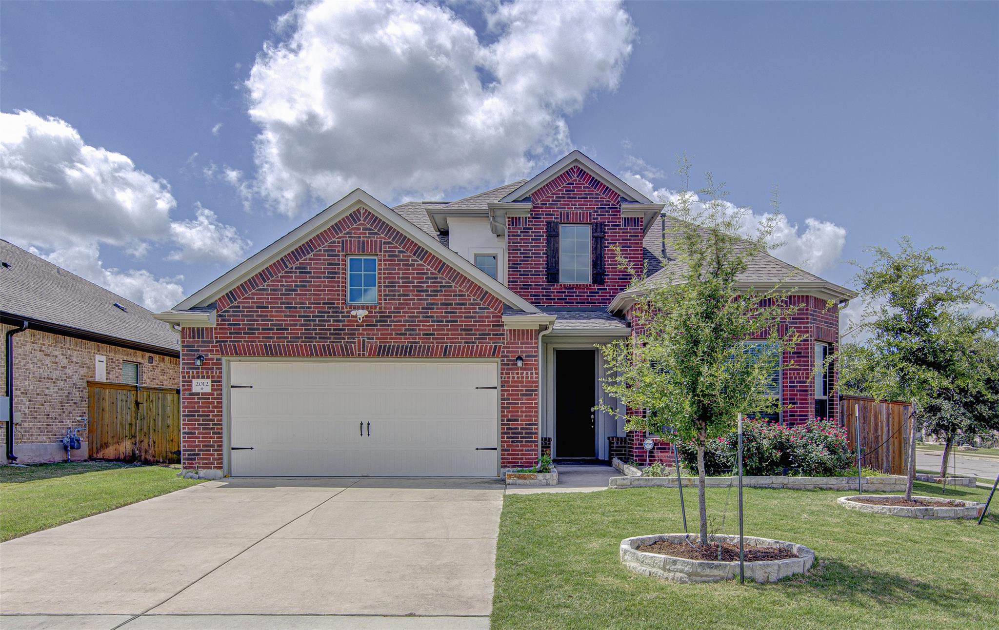 A classic brick facade welcomes you home, complet