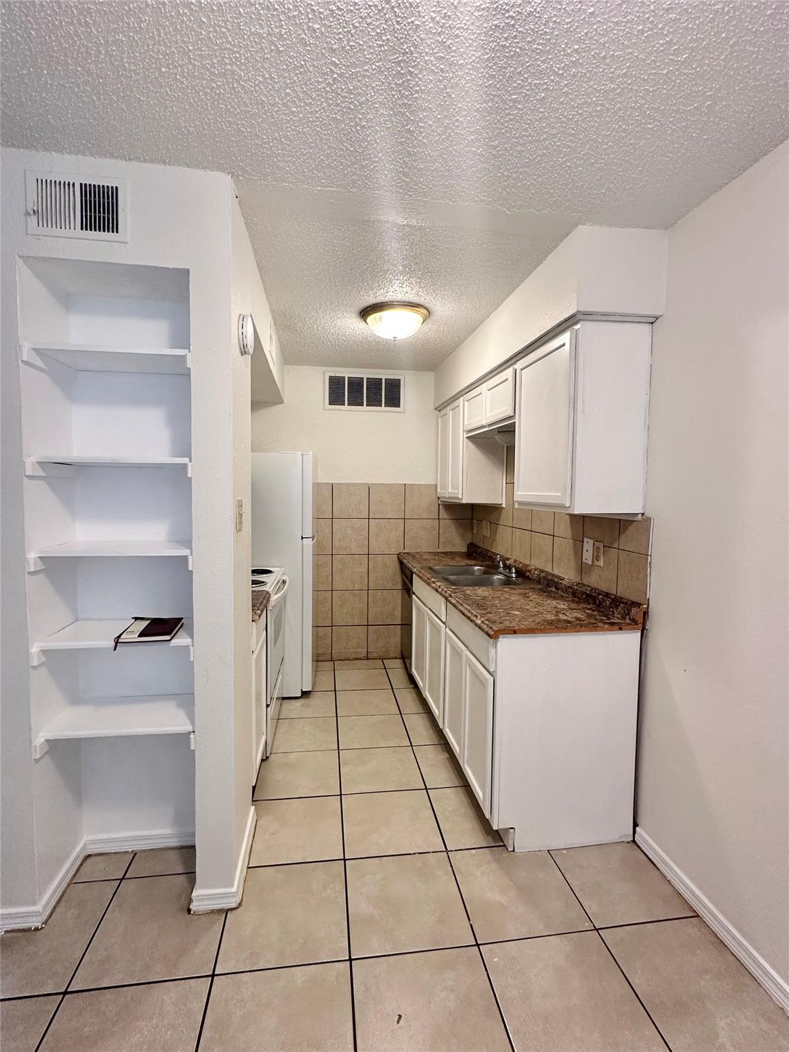 An inviting kitchen features ample storage with b