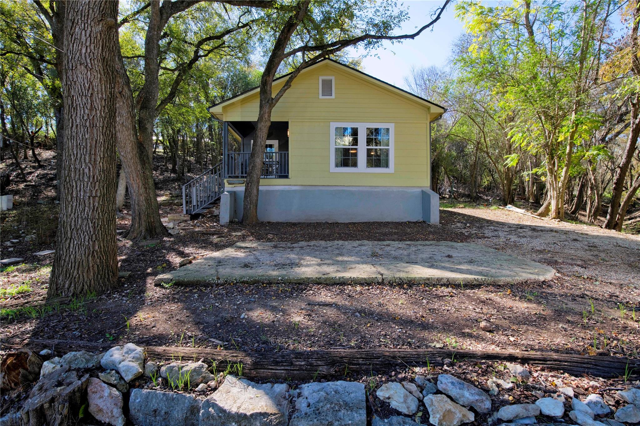 A charming yellow home nestled amidst natural lan