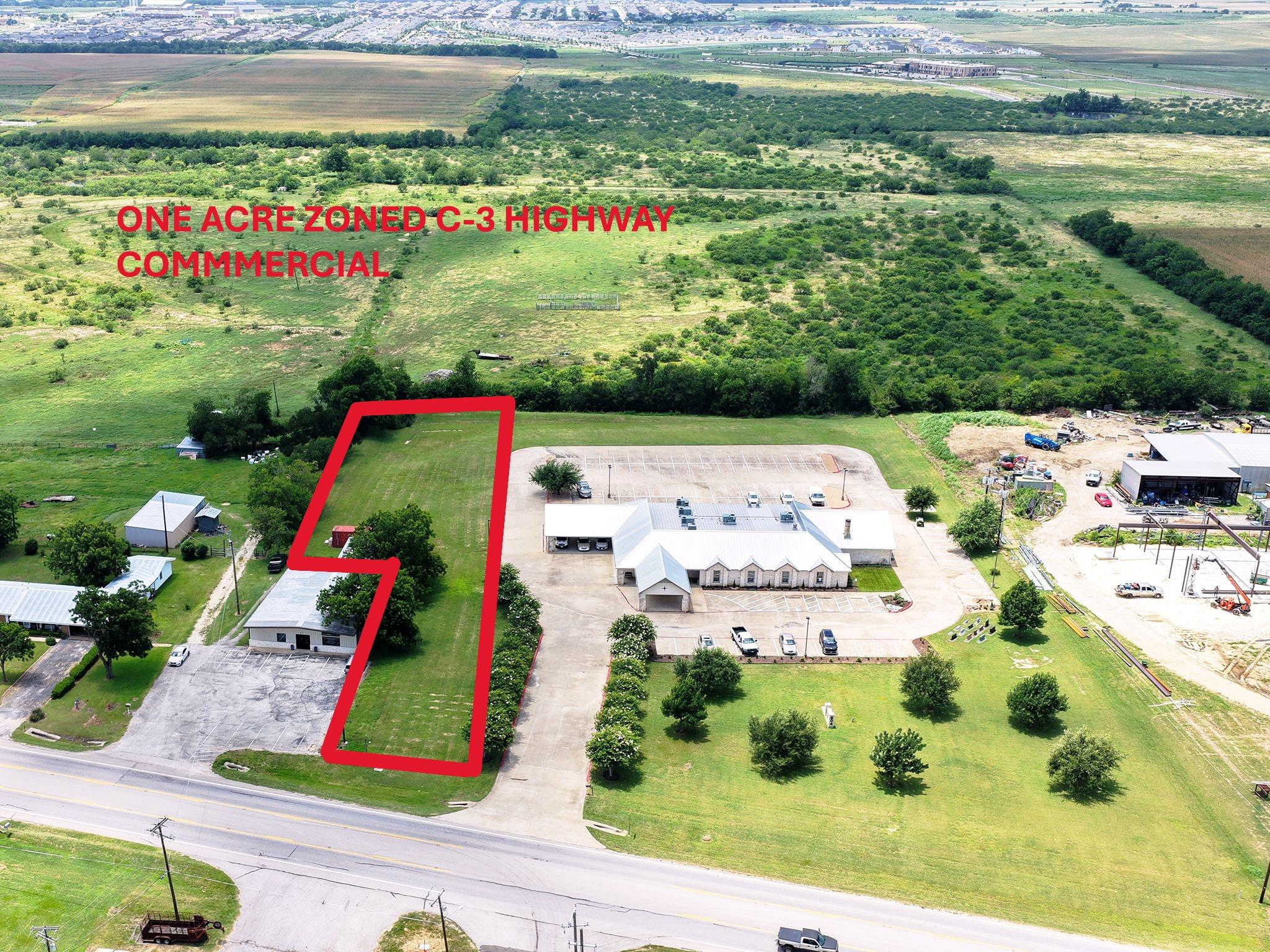 Aerial view highlights a prime commercial lot wit