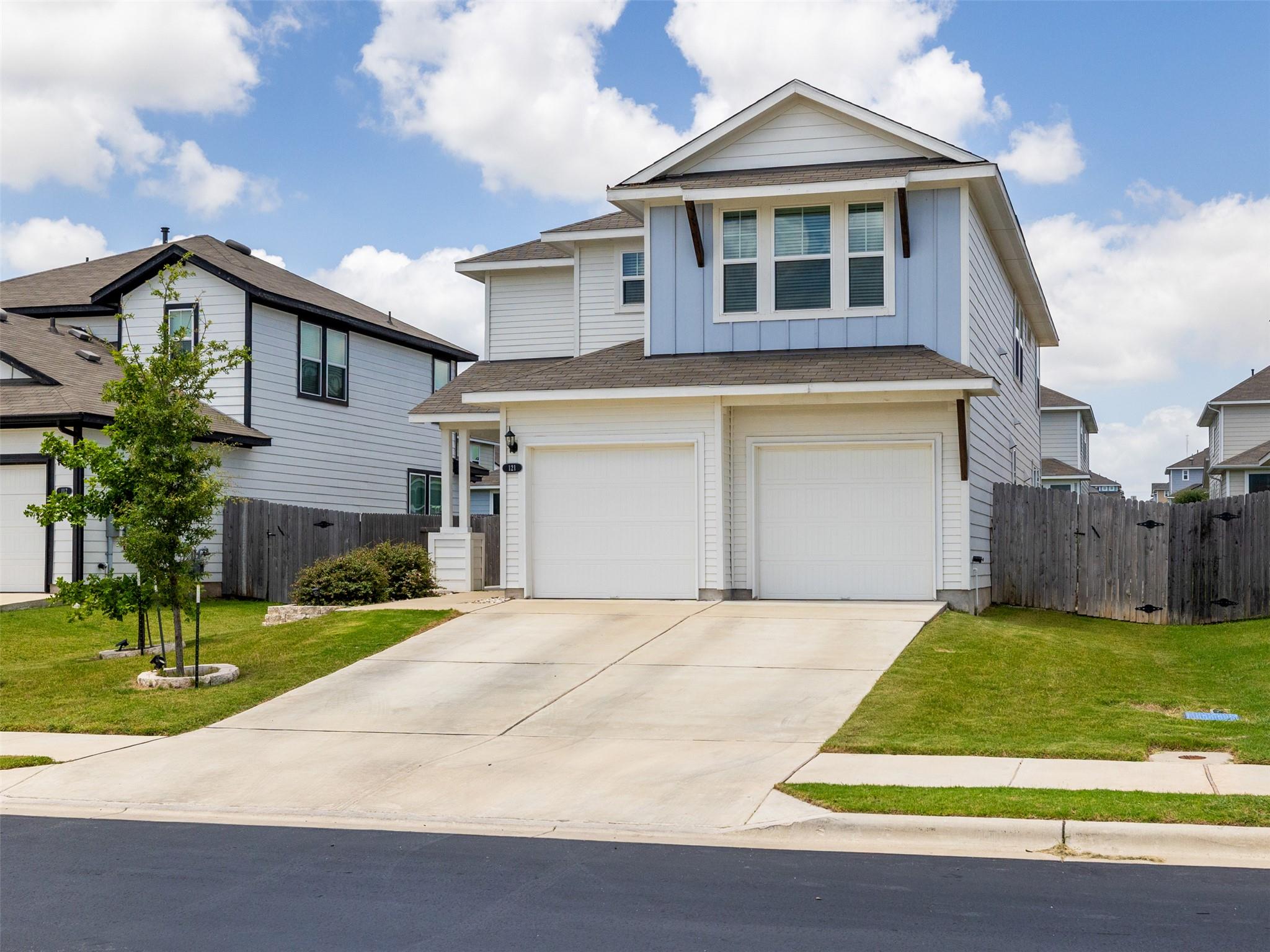 A well-maintained facade with a dual garage and c