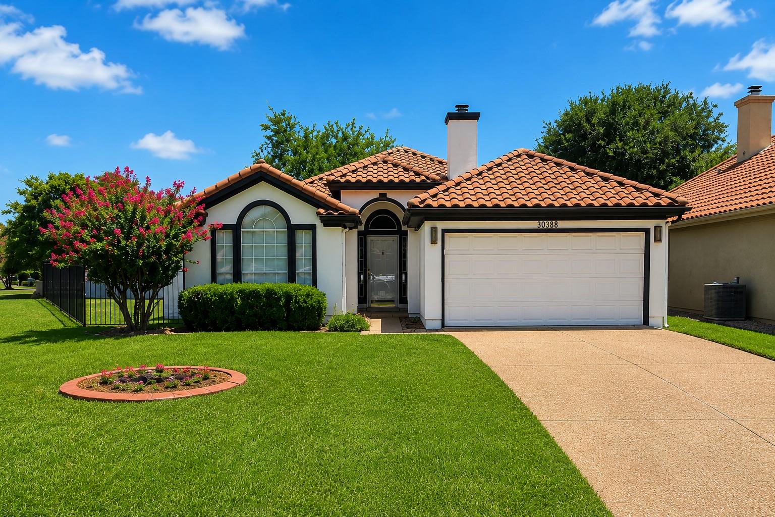 A terracotta-tiled roof crowns this appealing res