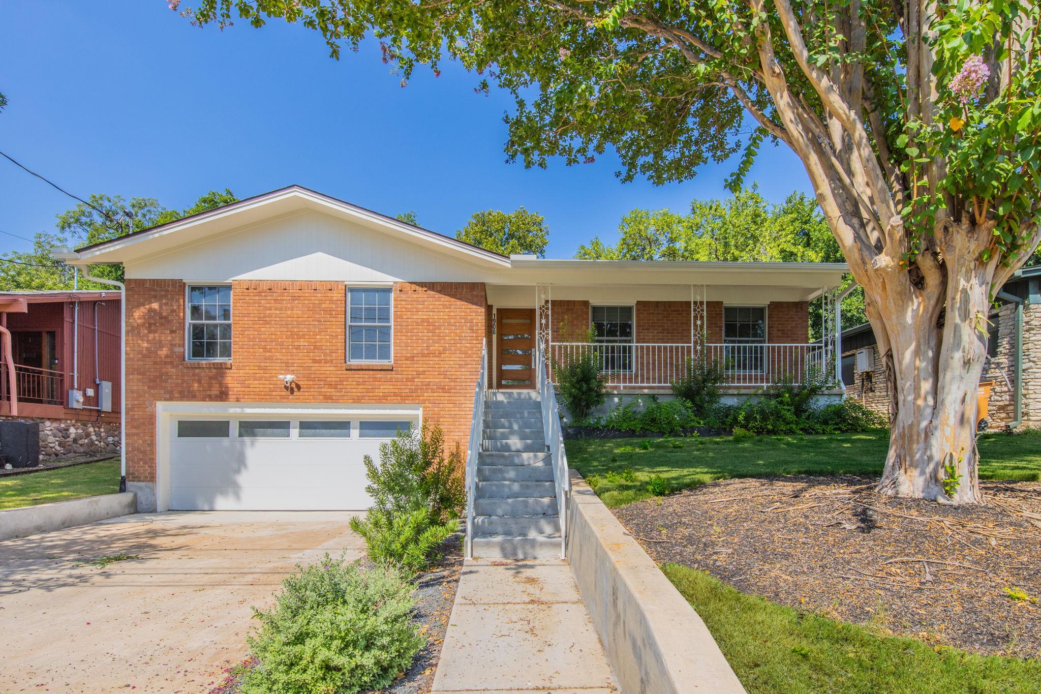 Brick facade with an integrated garage welcomes v