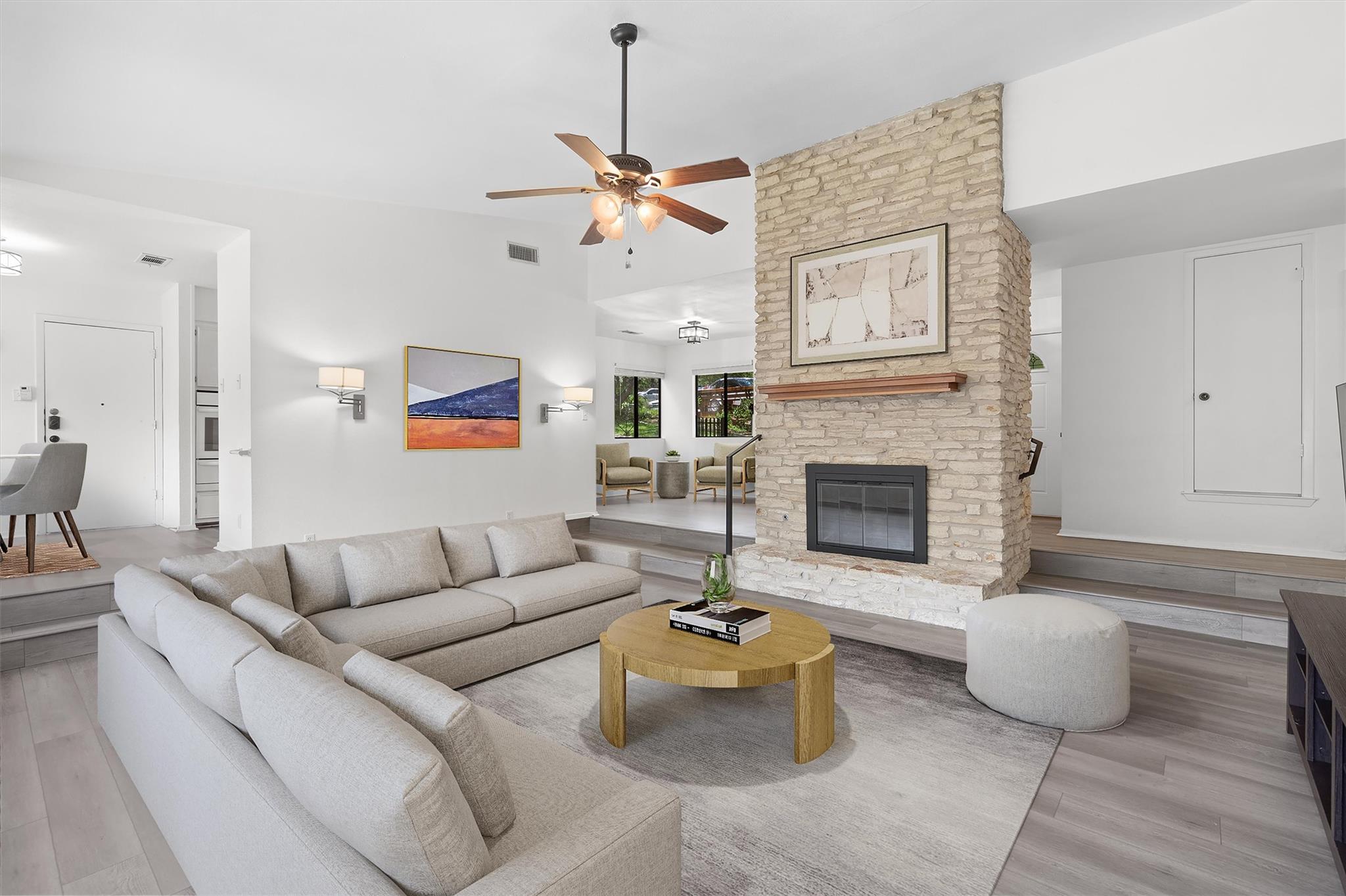 A striking stone fireplace anchors this spacious 