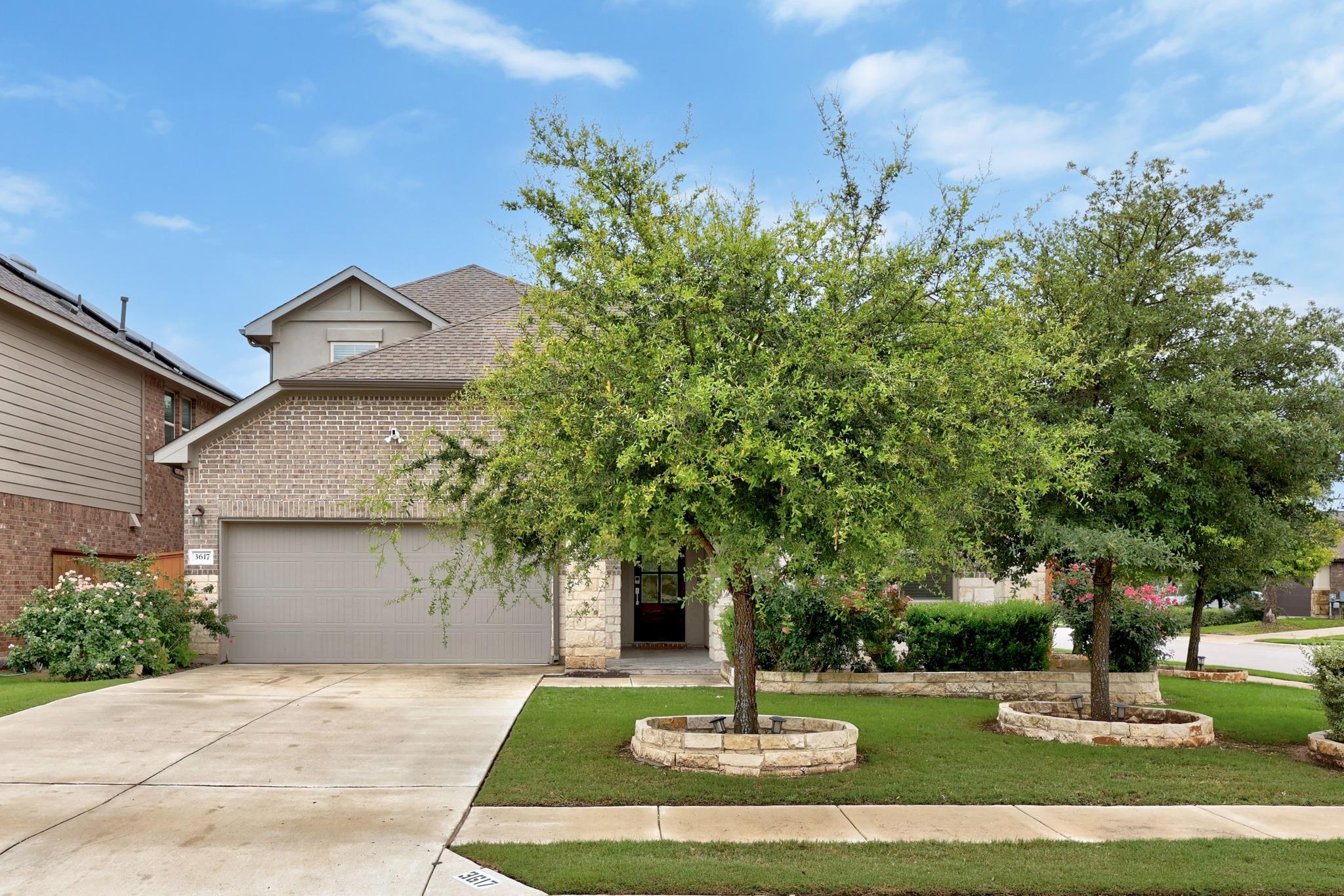 Well-maintained landscaping and a spacious drivew