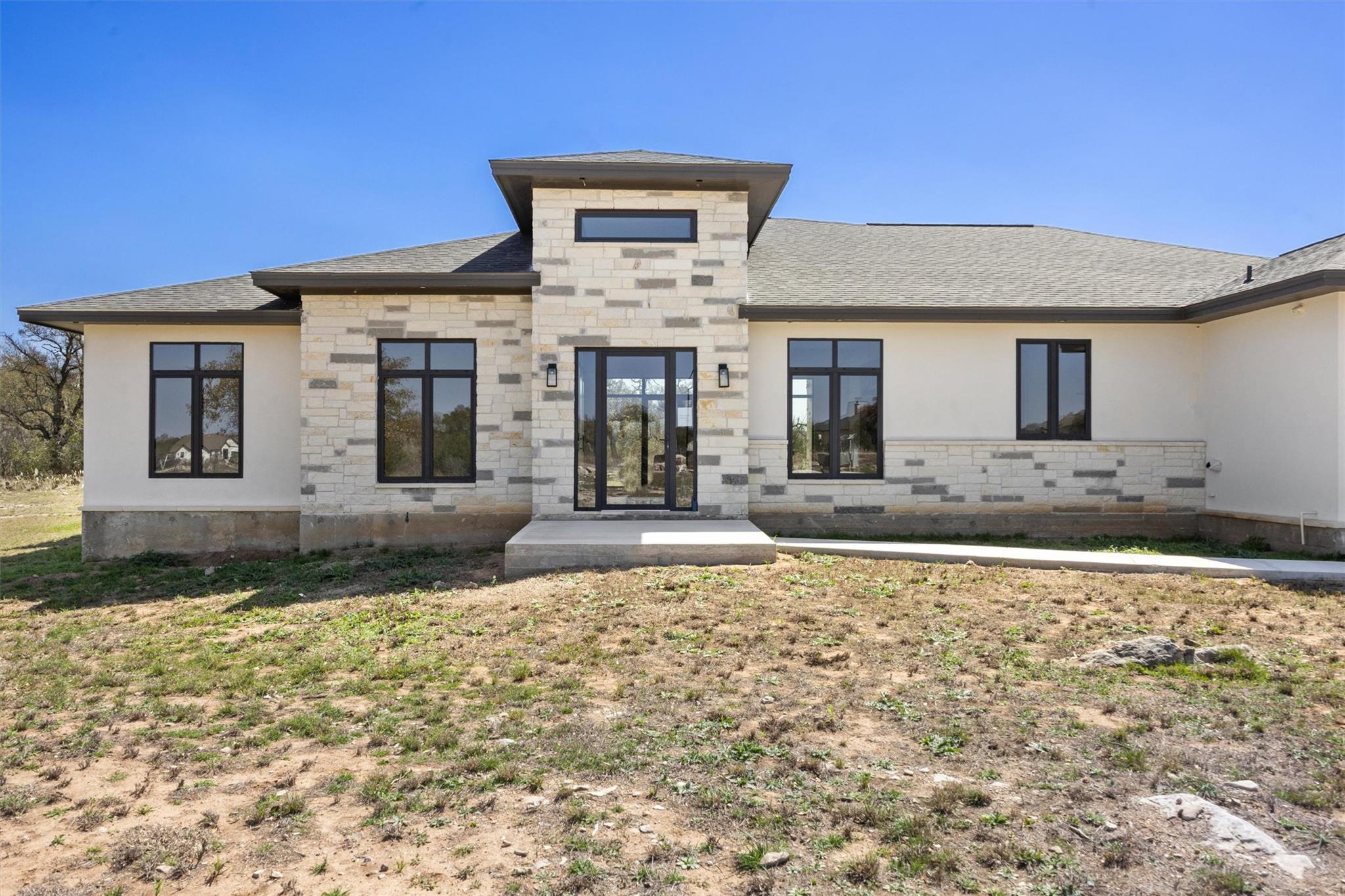A modern facade with striking stone and stucco, f