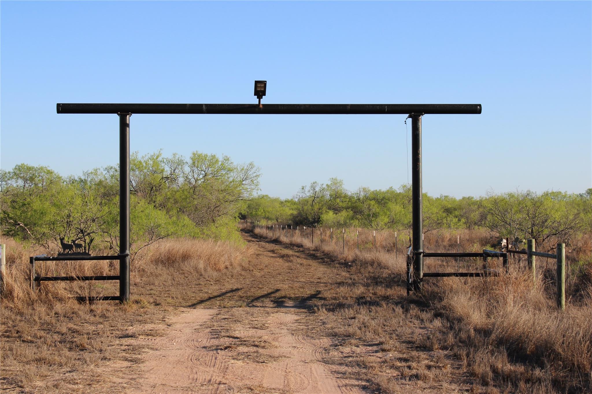 A private entry gate leads to a winding dirt path