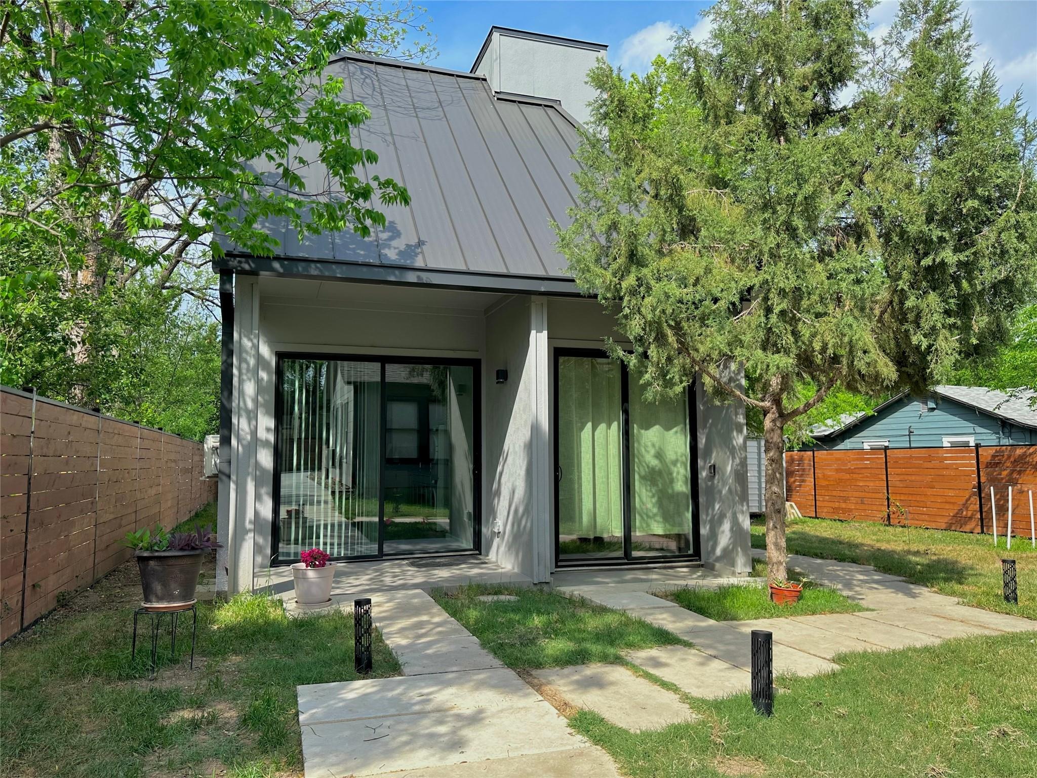 Rear view of house with a standing seam roof