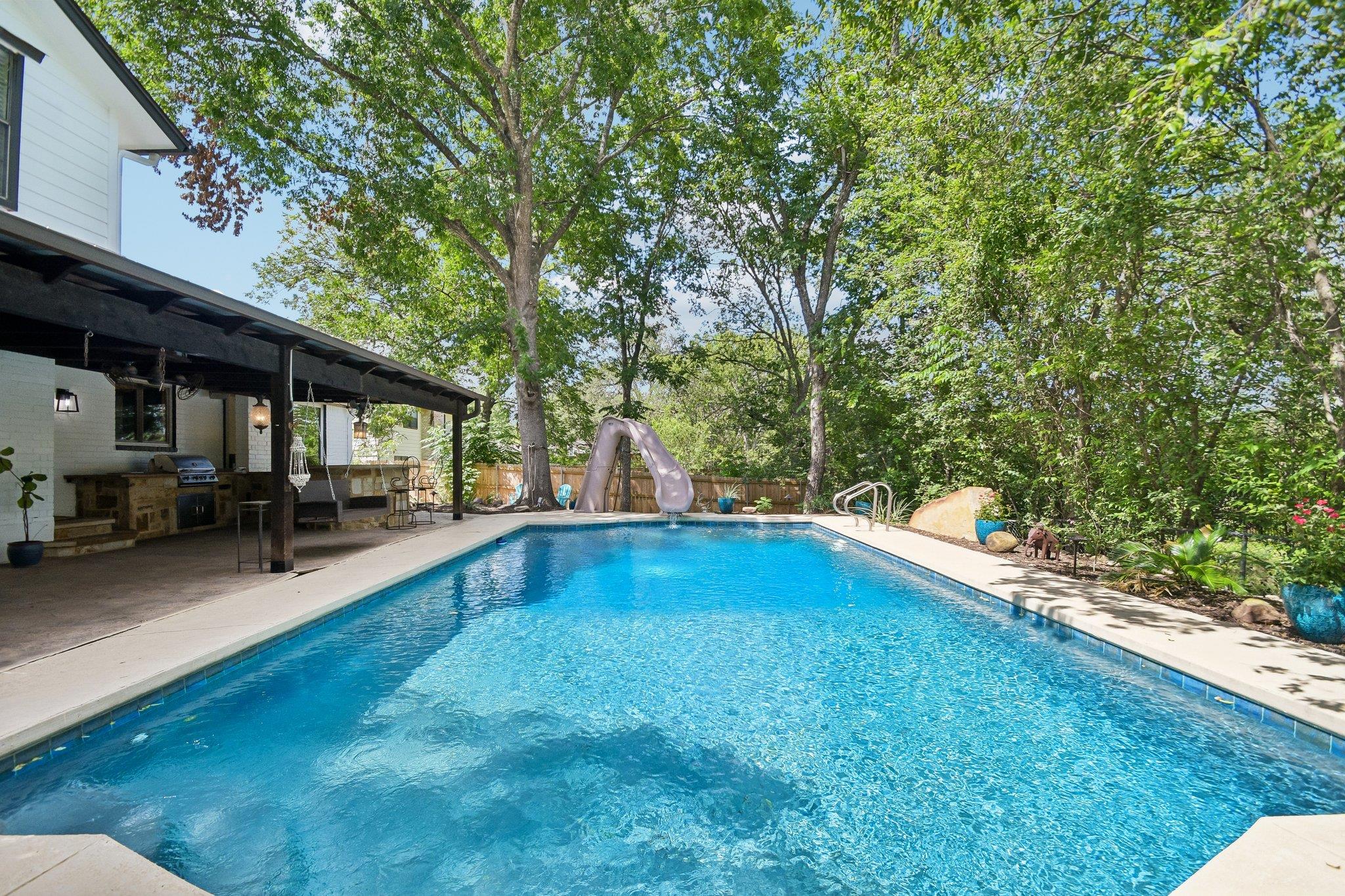 A private outdoor oasis features a shimmering in-