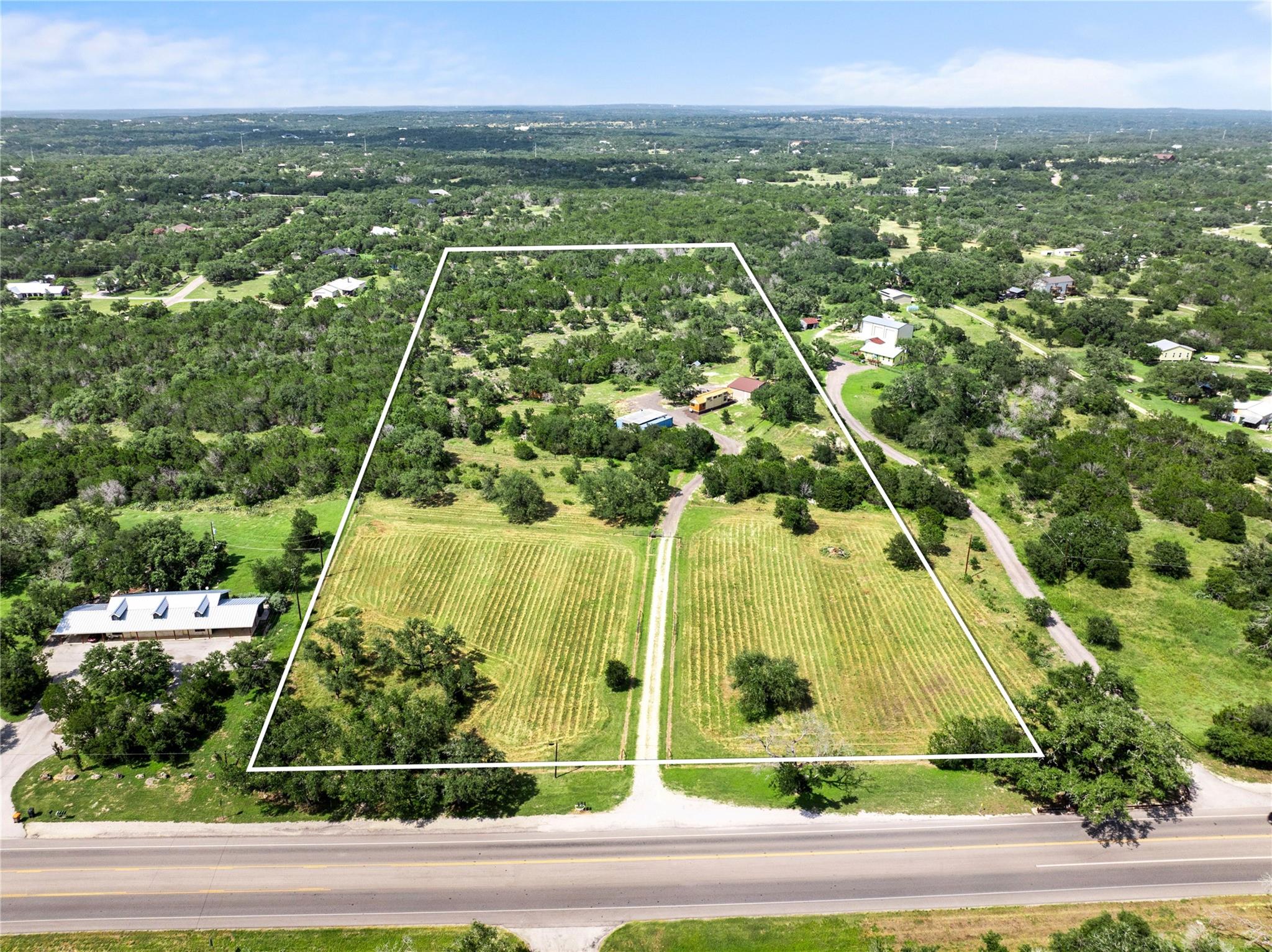 A spacious, verdant lot awaits your vision, borde
