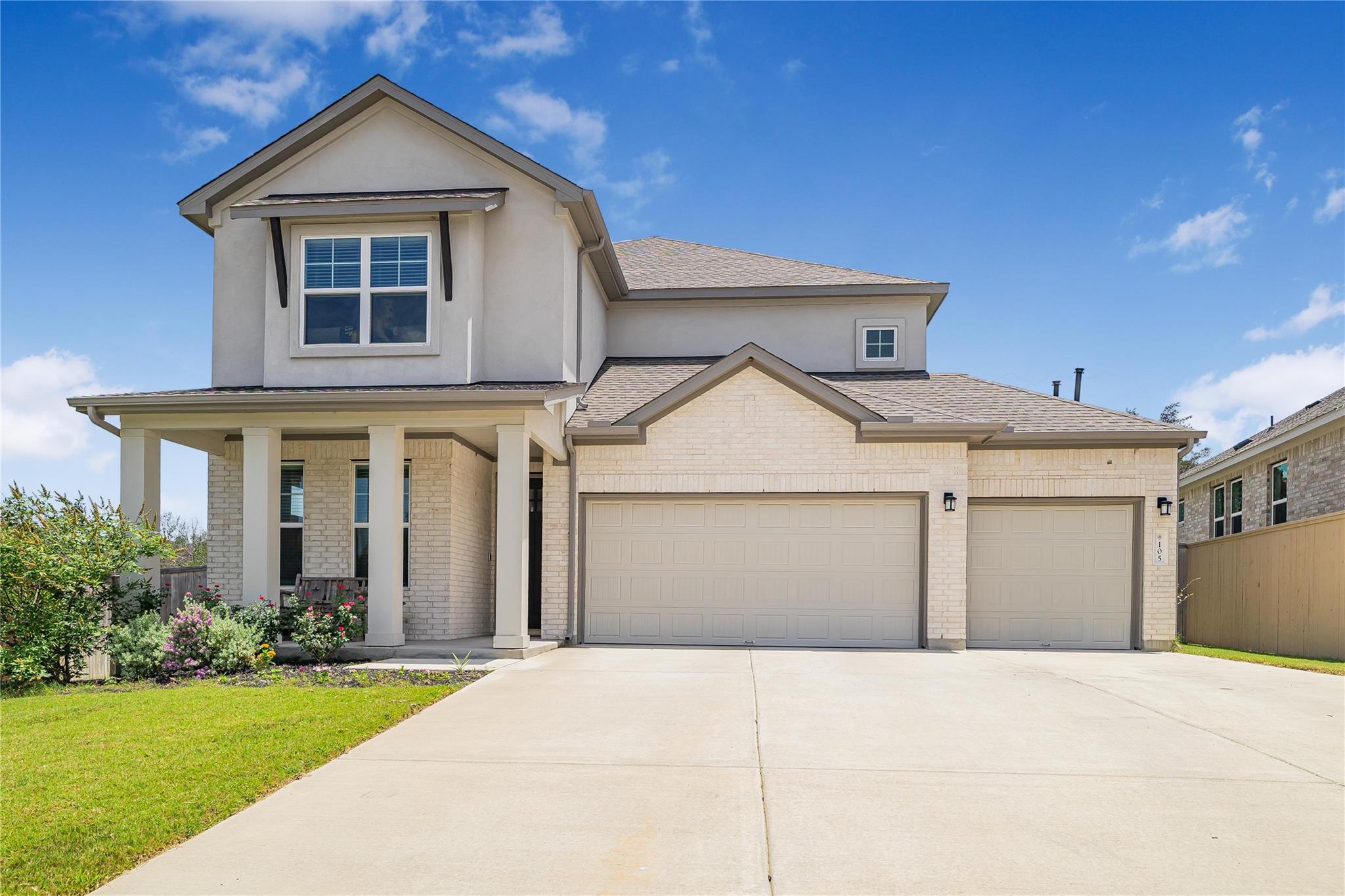 A well-maintained facade features an inviting cov