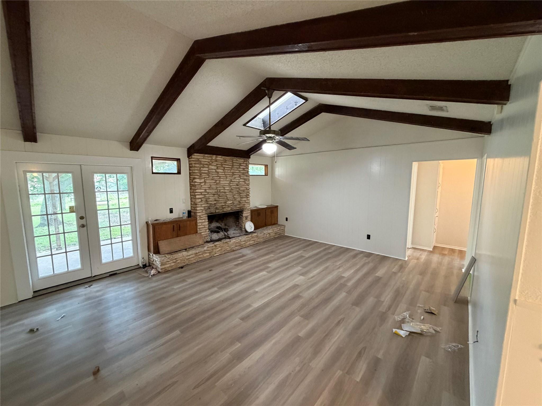 A spacious living area features high ceilings, a 