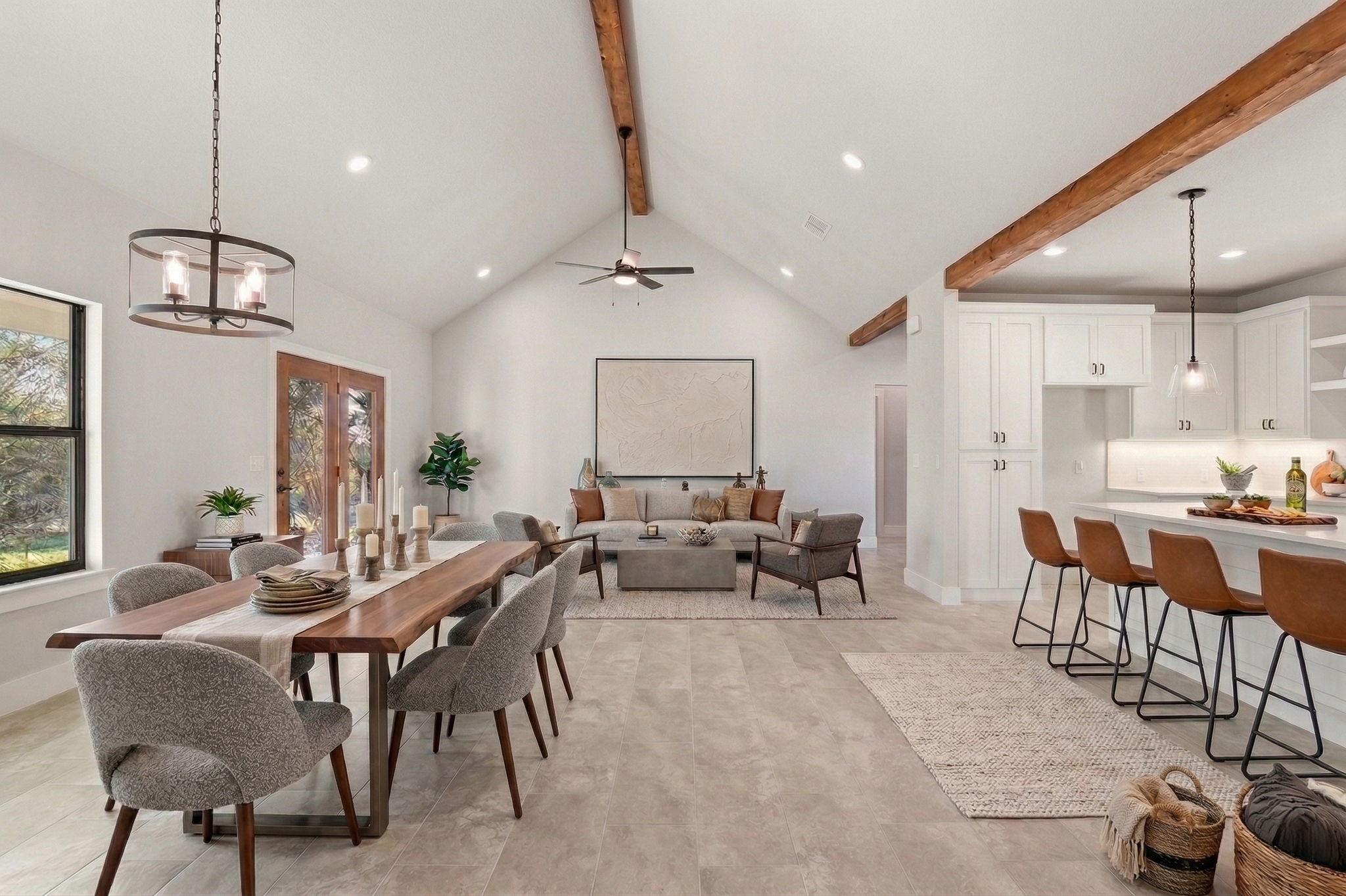 An open-concept living space with exposed beams a