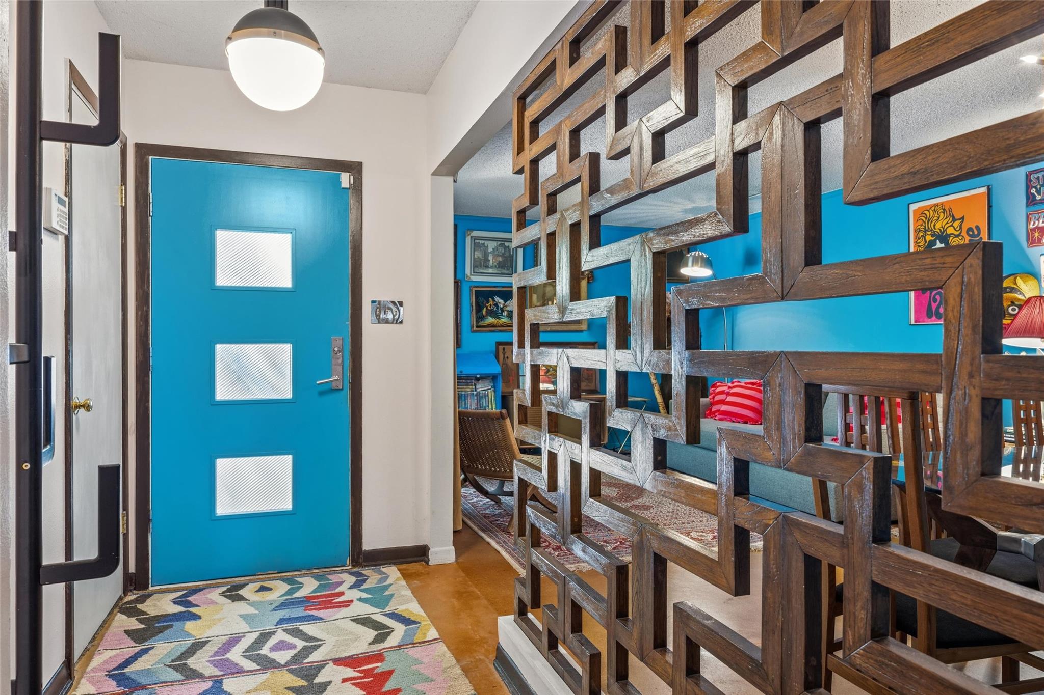 A vibrant blue entry door welcomes guests, comple