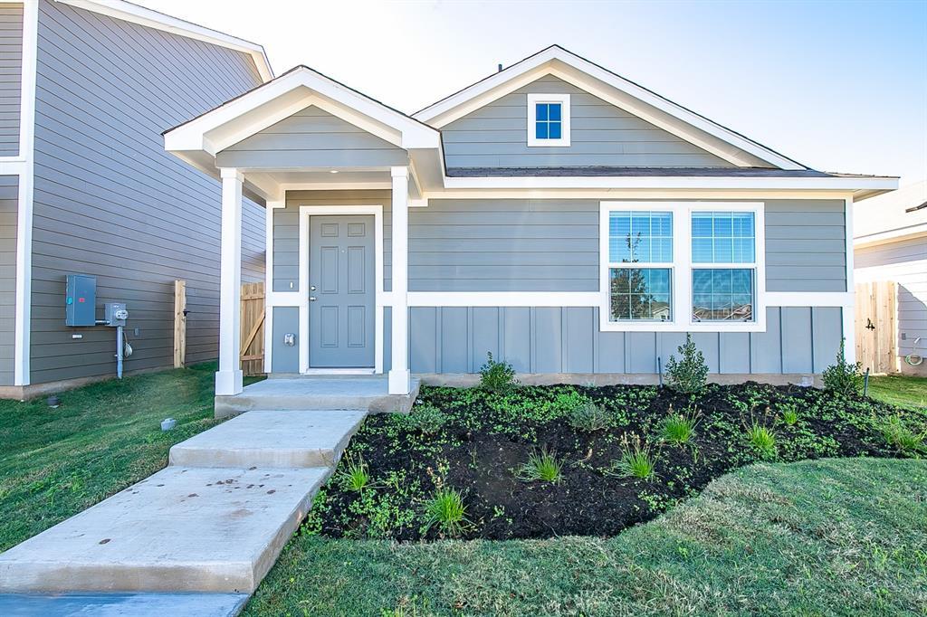 A welcoming light blue exterior and manicured lan