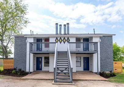 A clean, modern exterior with inviting stair acce