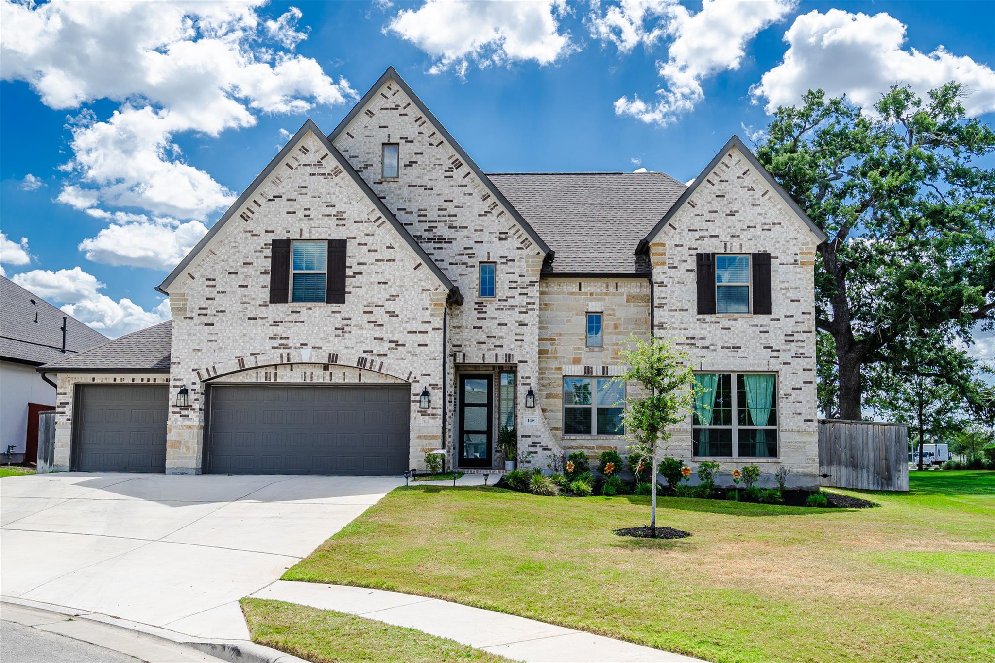 A charming facade of mixed stone and brick create