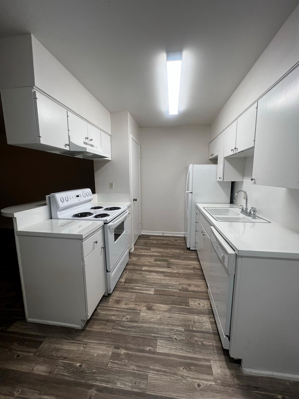 A well-equipped galley kitchen offers ample white