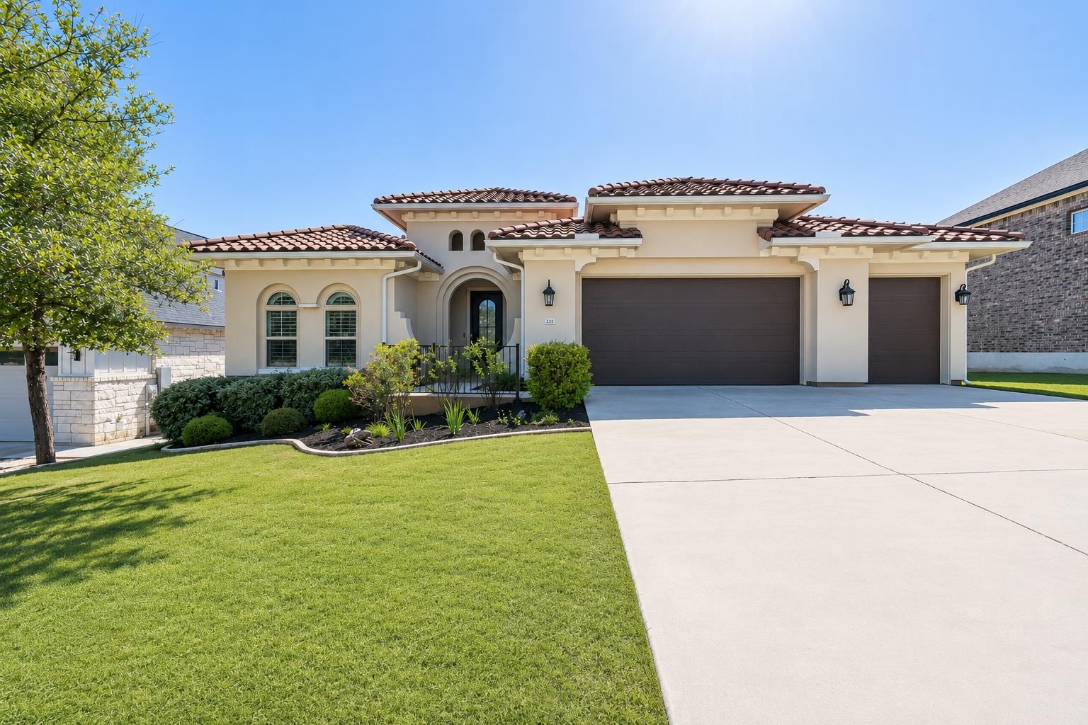 Spanish-inspired home with well-manicured lawn an