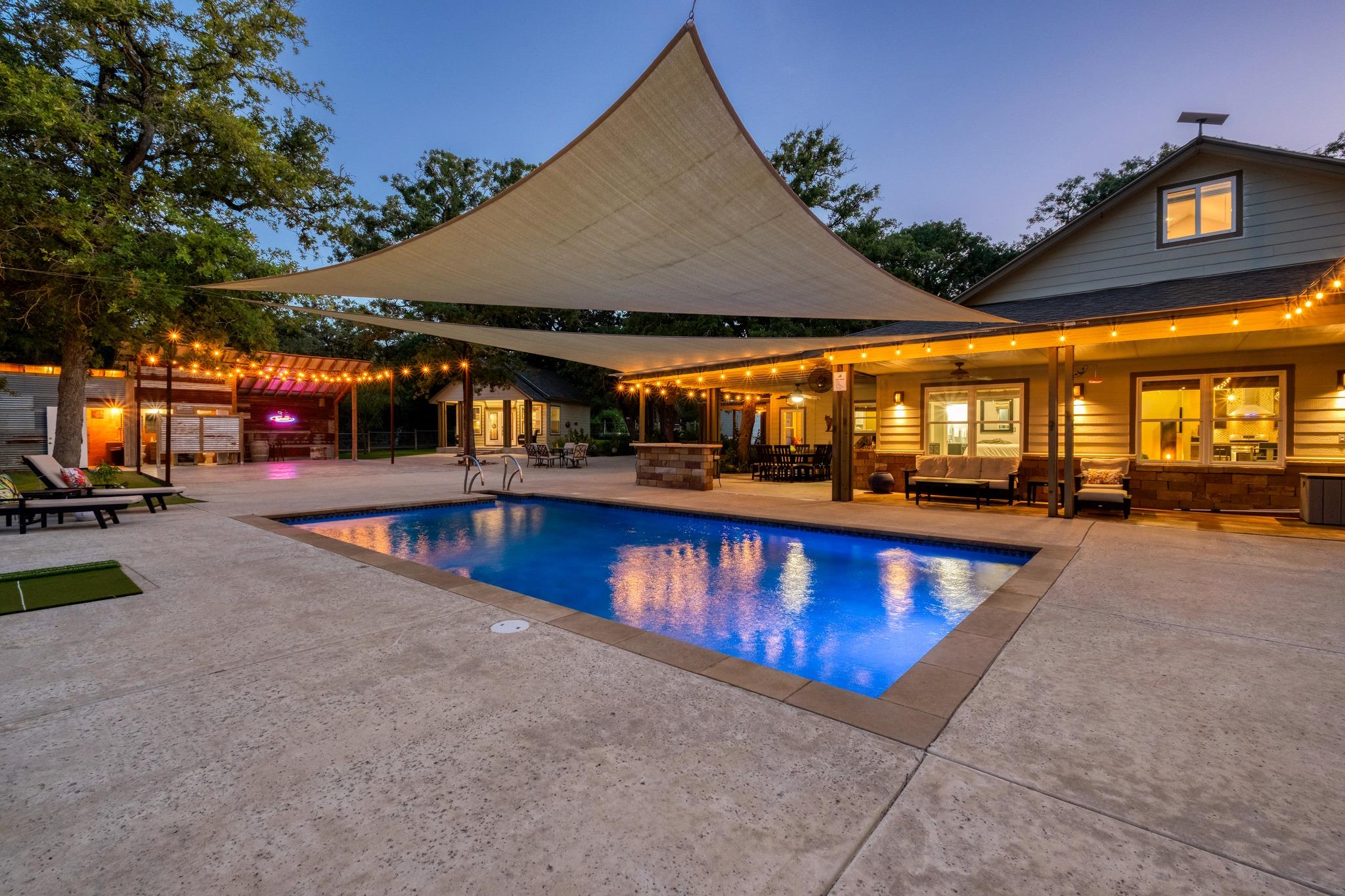 An inviting backyard oasis offers a sparkling in-
