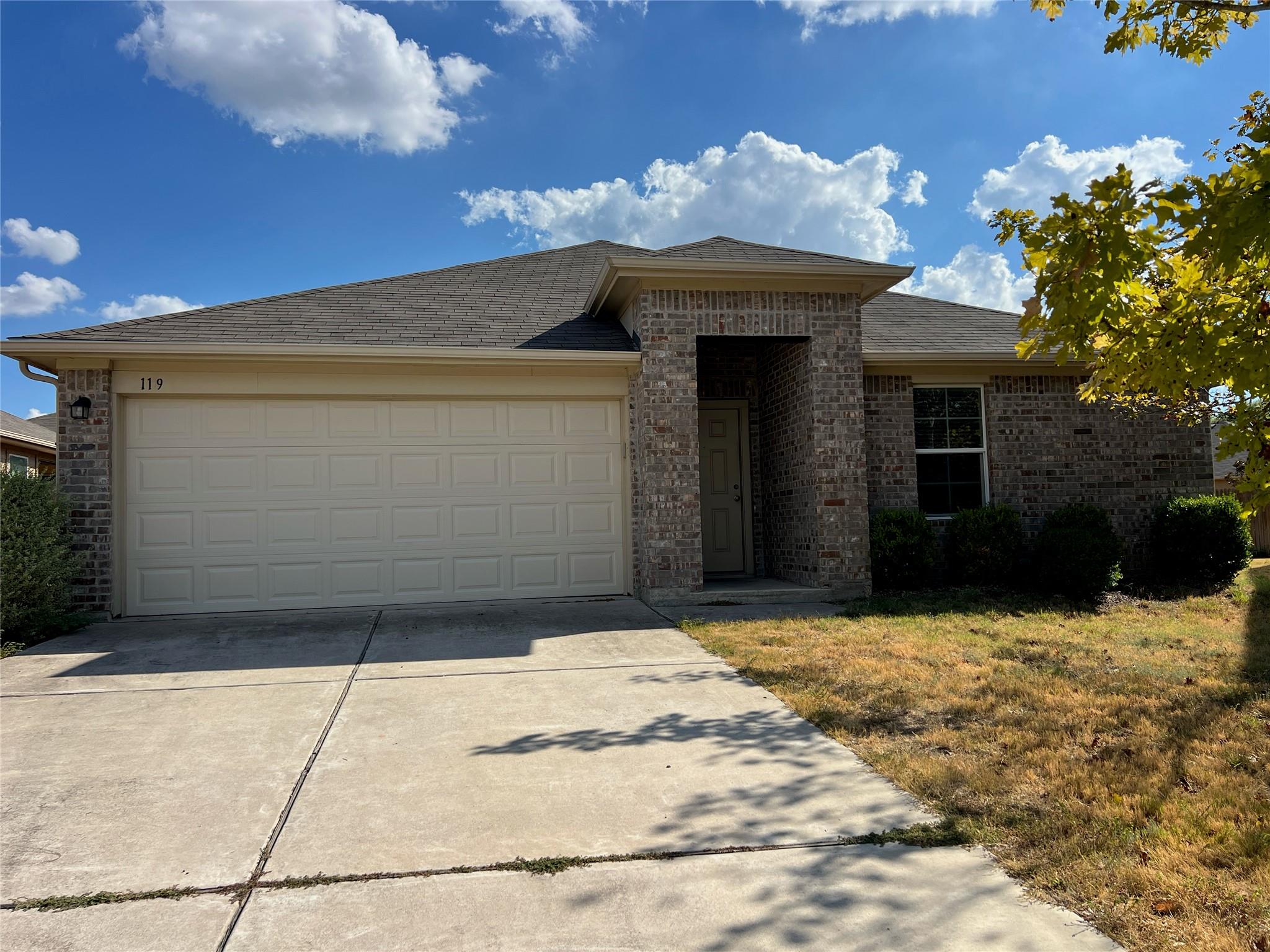 A classic brick exterior, neat driveway, and inte