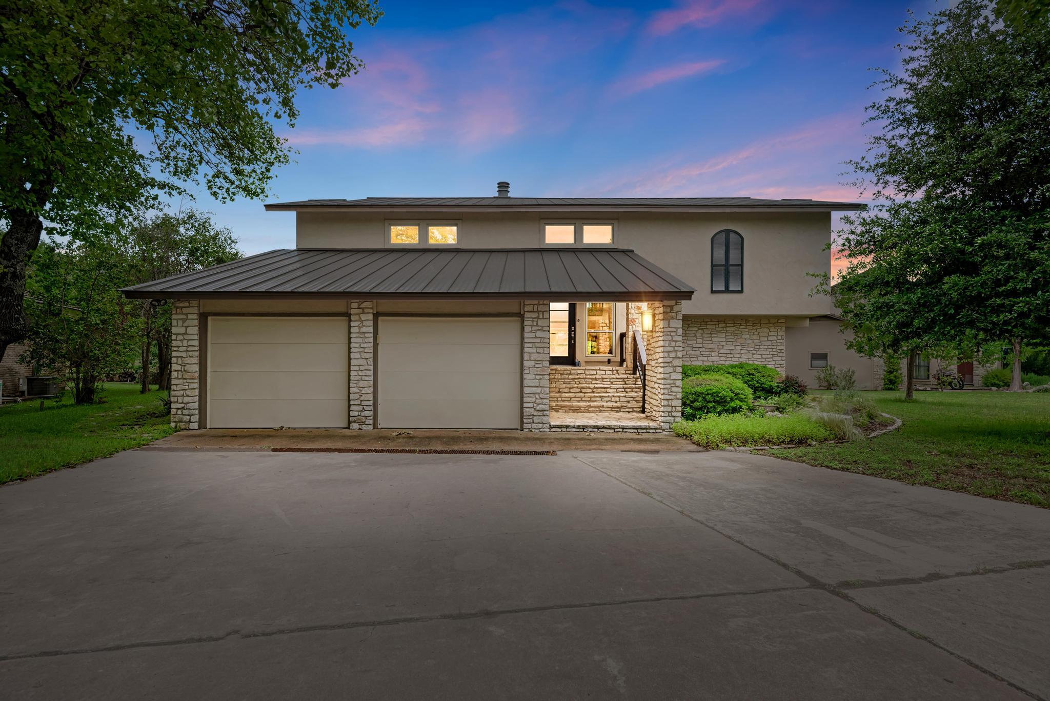 A welcoming stone facade with a spacious concrete
