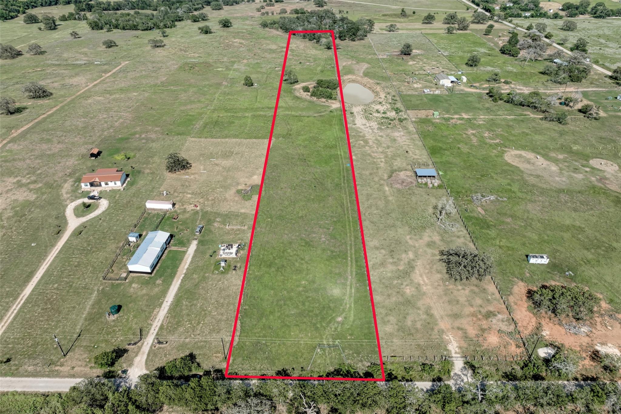 A verdant parcel of land, ripe for building, awai