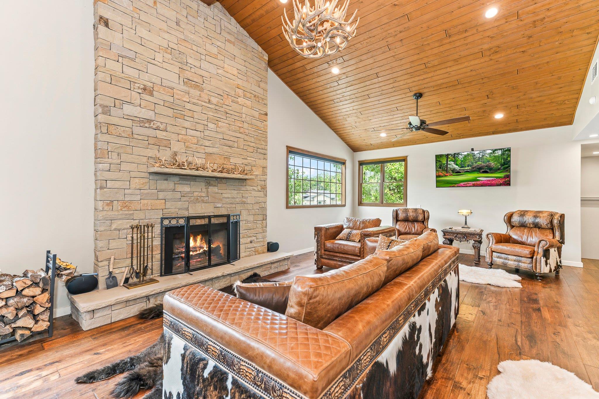 A spacious great room featuring a grand stone fir