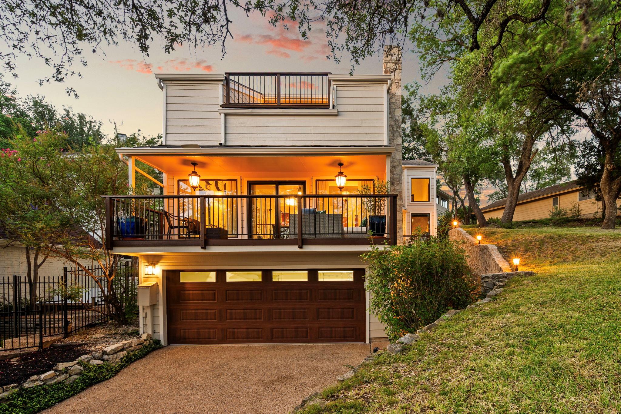 A spacious garage and inviting upper deck create 