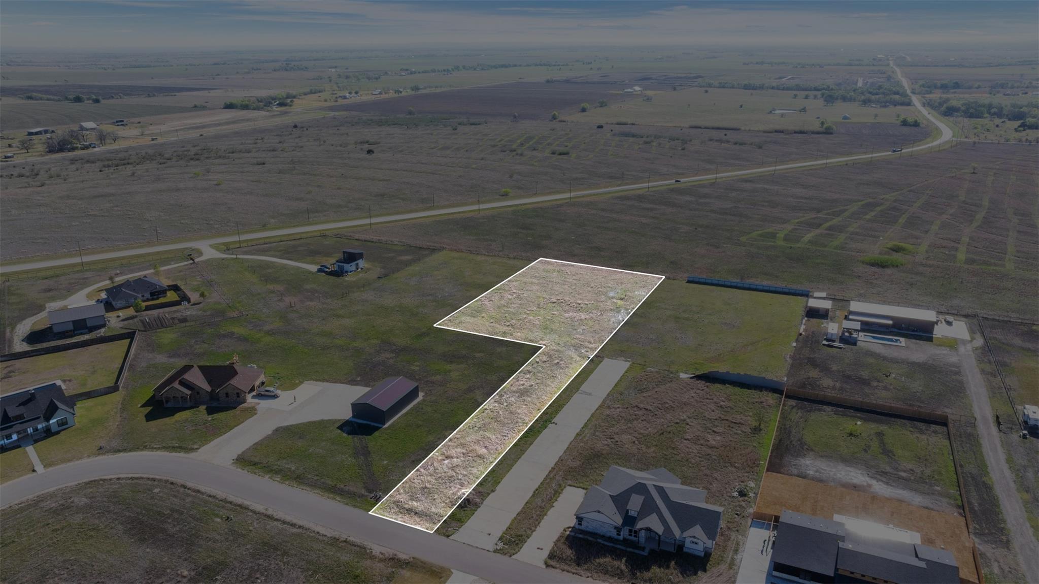 A spacious, buildable lot awaits your vision, bor