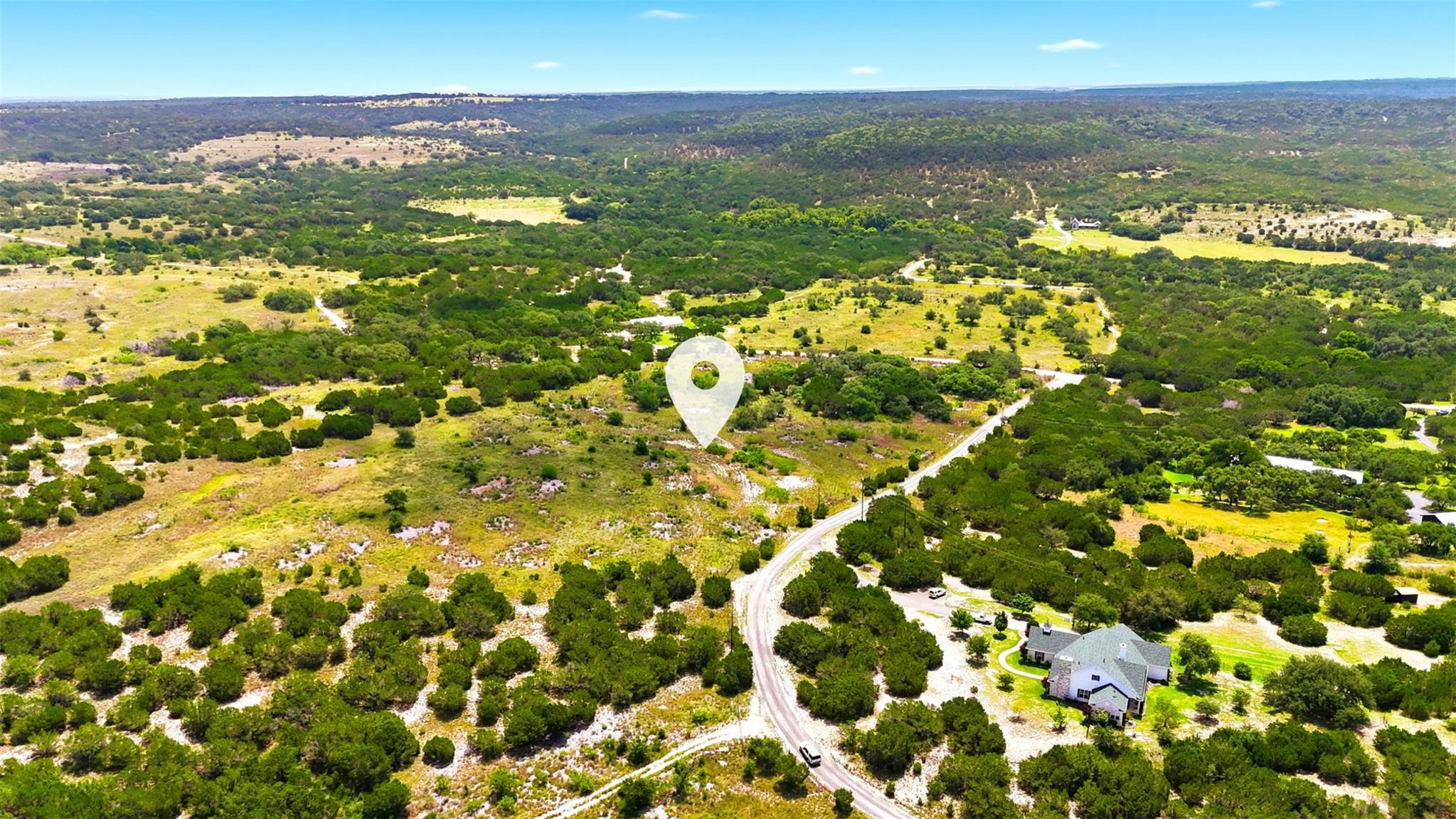 Vast, verdant landscape with a secluded residenti