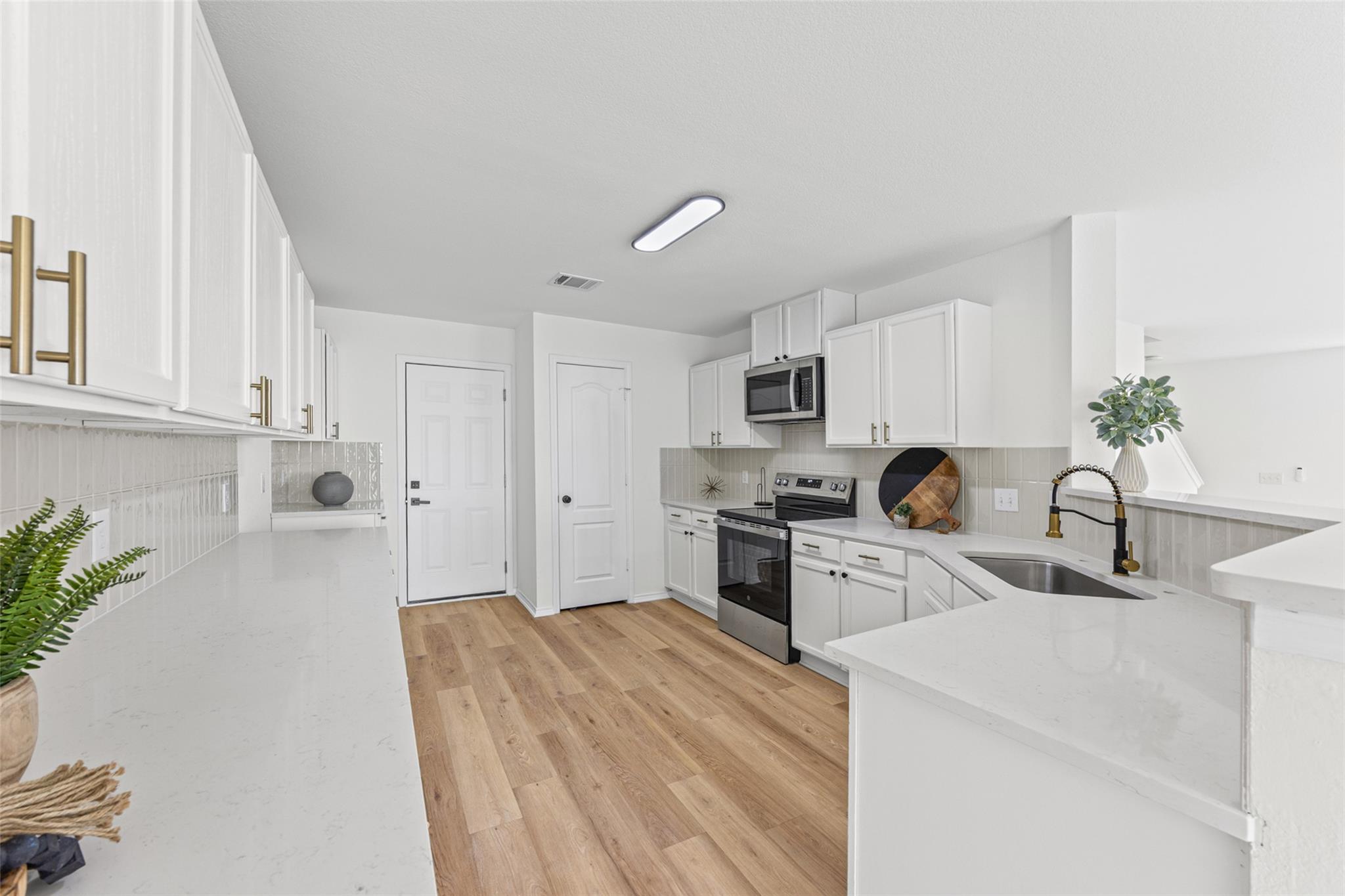 A well-appointed kitchen features ample counter s