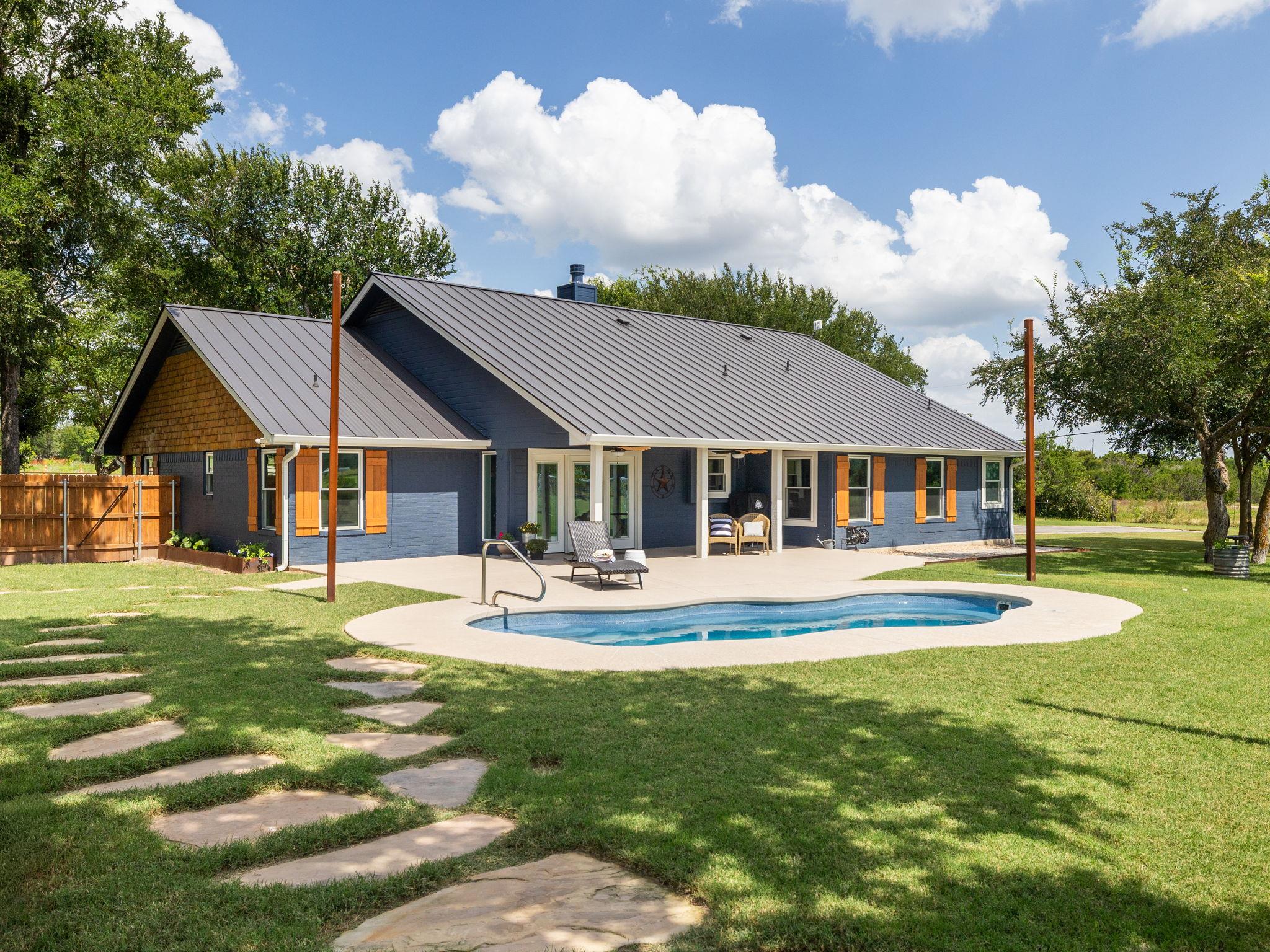 A private swimming pool and expansive patio creat