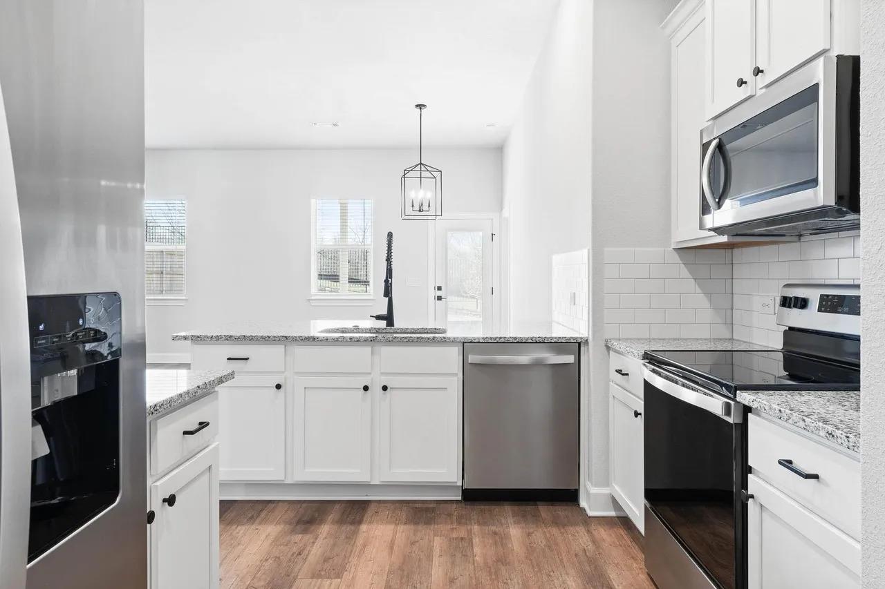 A well-appointed kitchen features ample counter s