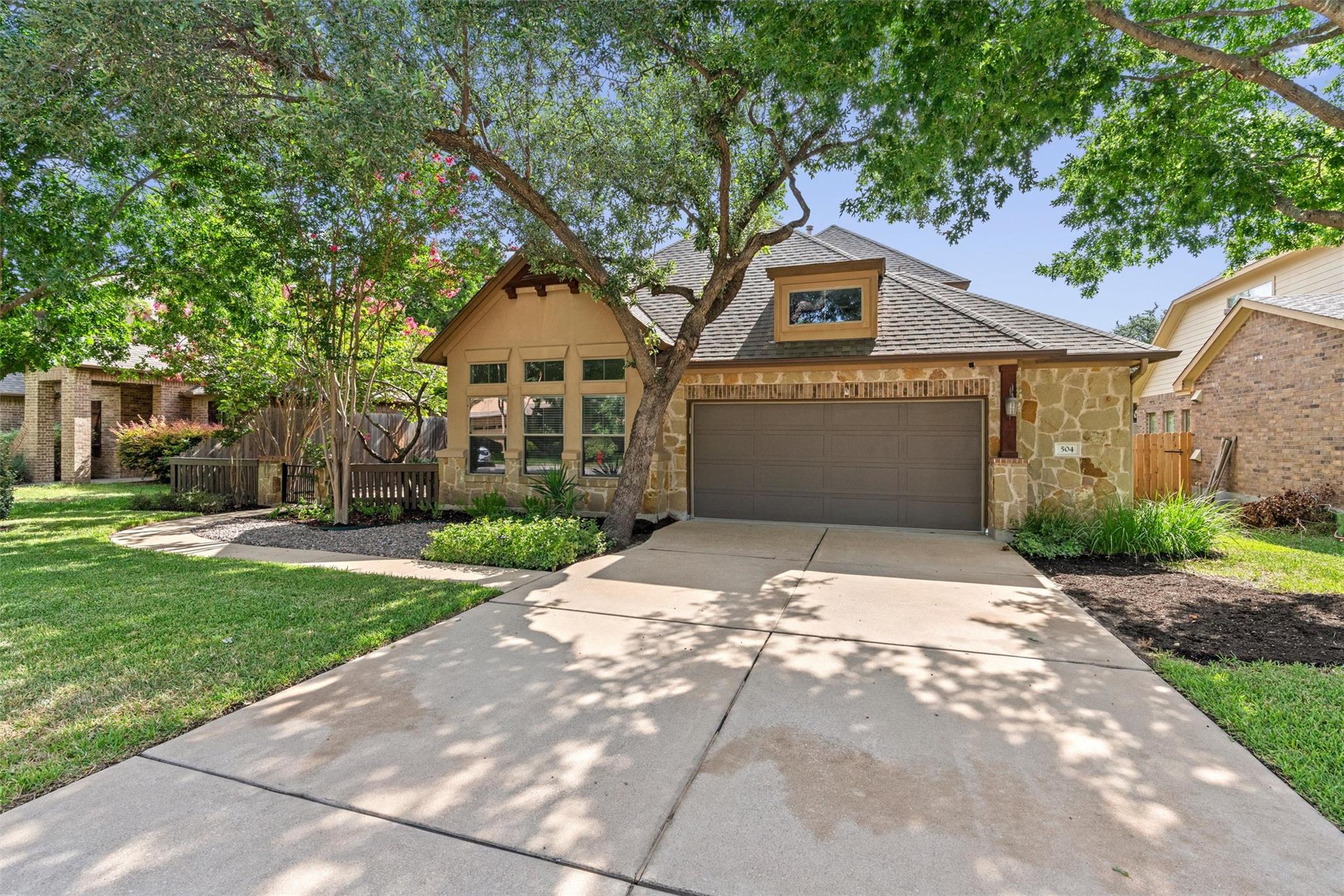 Mature trees frame this charming residence, boast