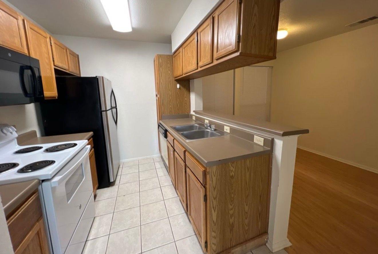 A well-appointed kitchen showcases ample cabinetr