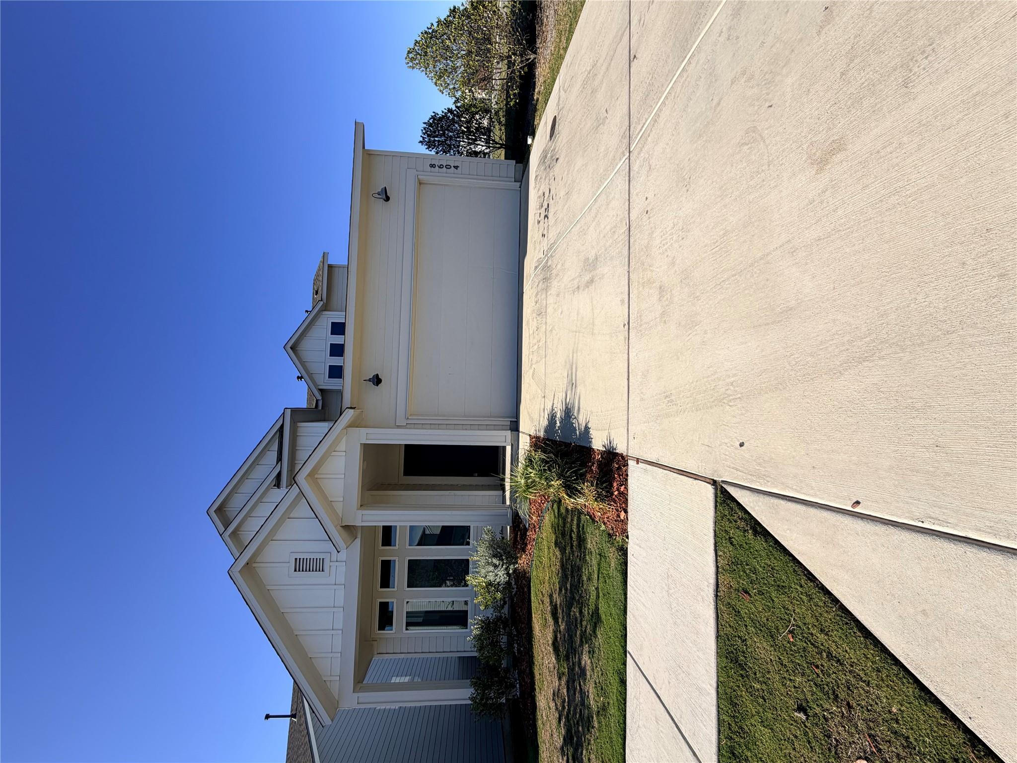 View of front of property featuring driveway, a g