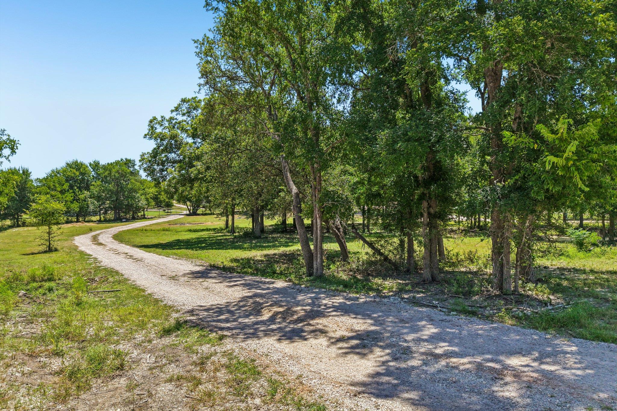 A winding gravel path beckons through verdant fie