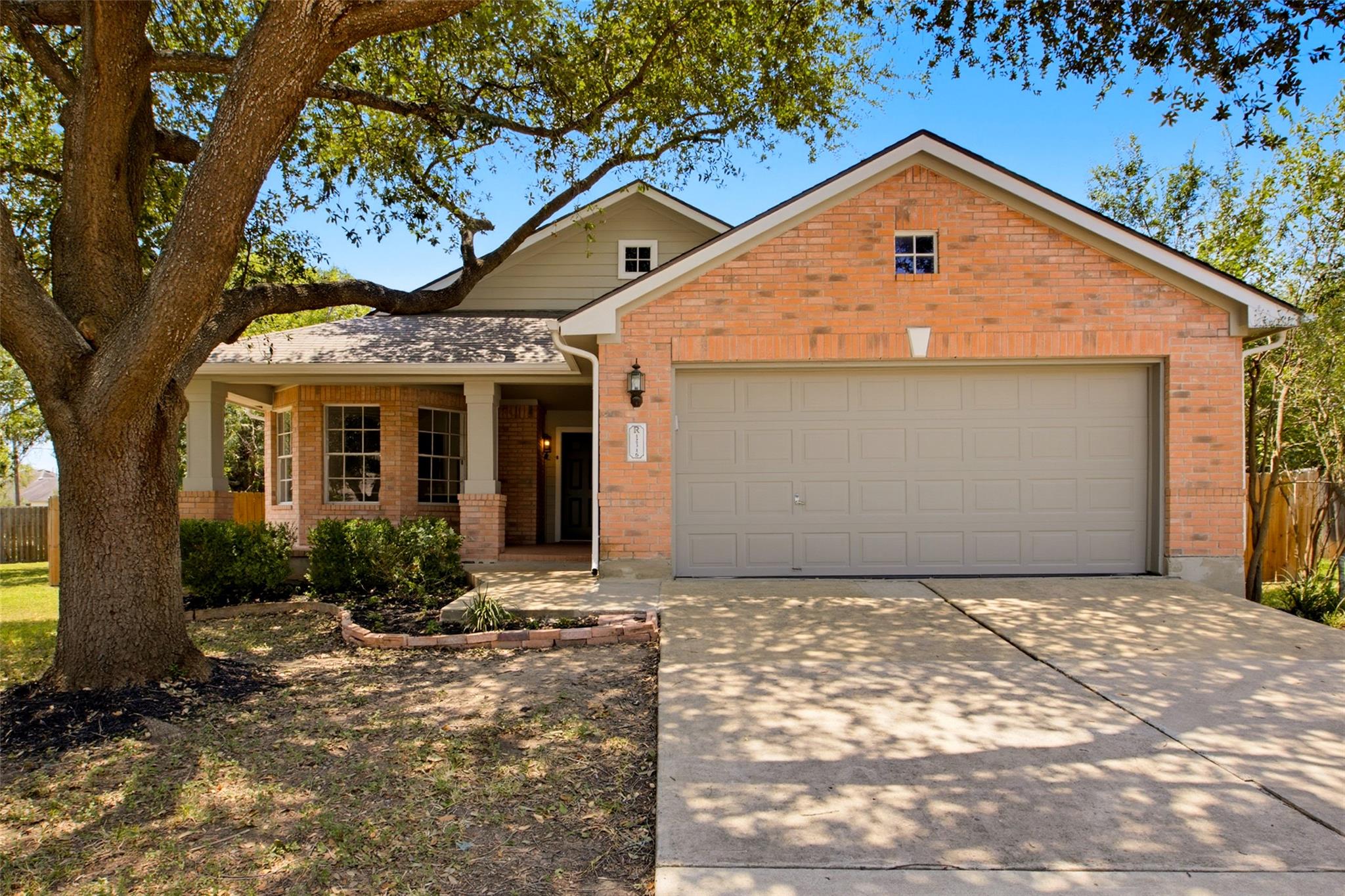 A well-maintained brick and siding home with a we