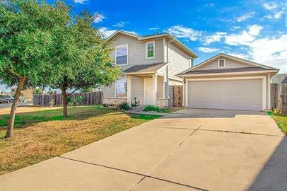 A classic two-story residence with an attached ga