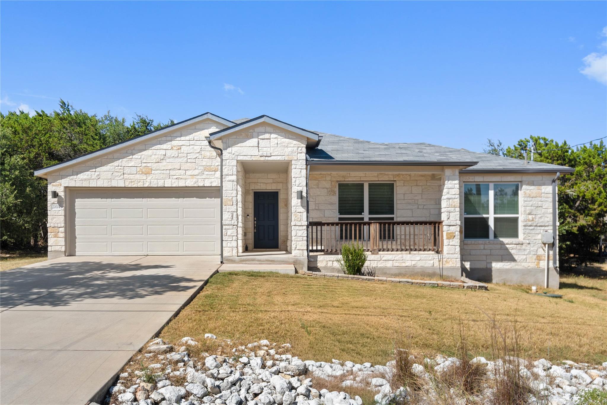 Limestone masonry accents the exterior of this si