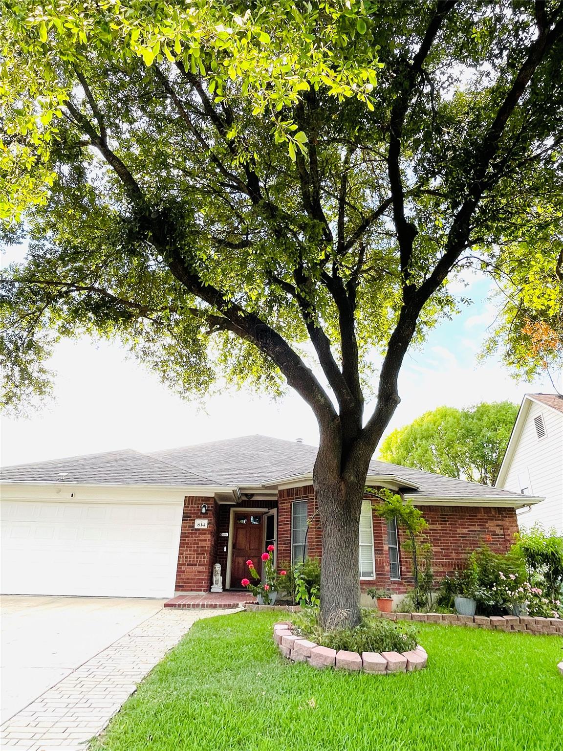 Mature trees and neat landscaping enhance the inv