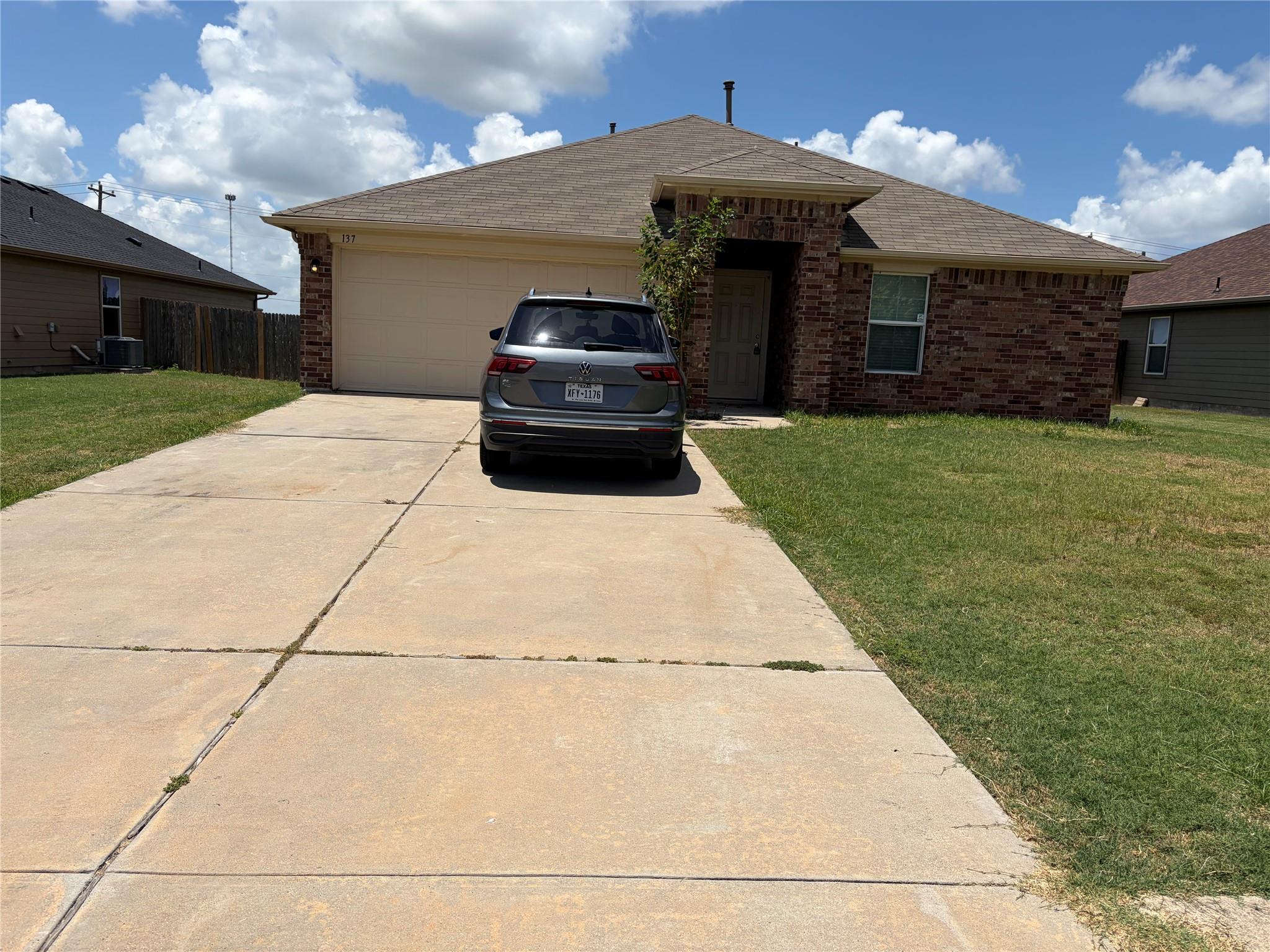 A classic brick exterior and attached garage offe