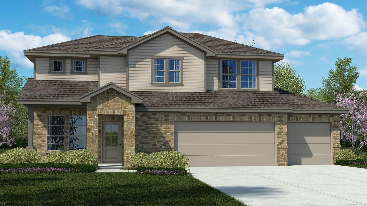 A classic exterior with stone accents and twin ga