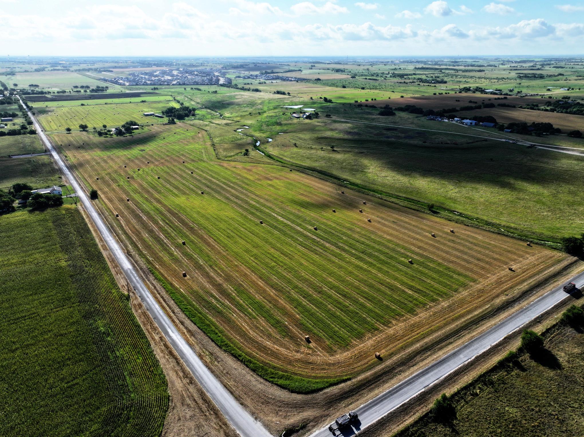 An aerial panorama reveals verdant fields stretch