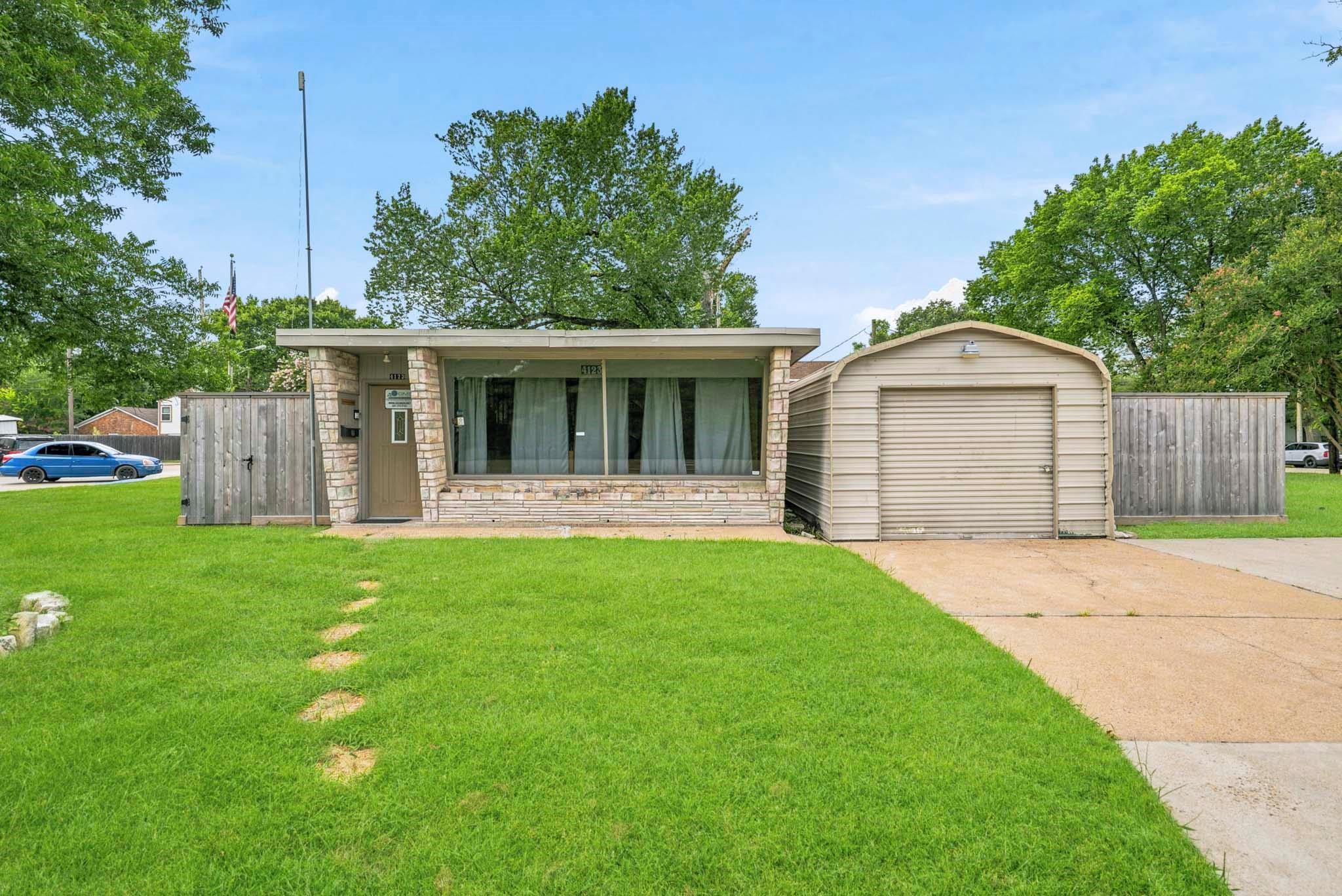 A well-maintained lawn welcomes visitors to this 