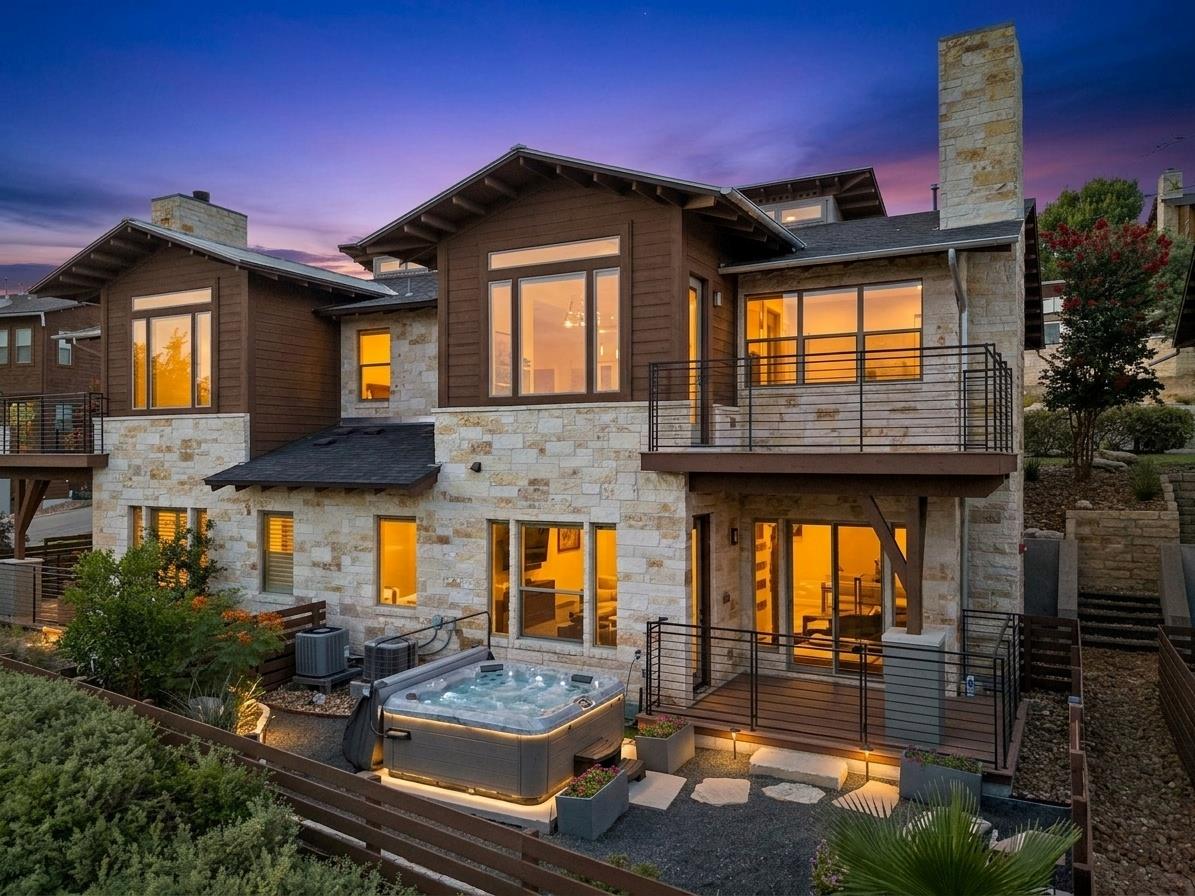 Stone and wood siding adorn this multi-level home