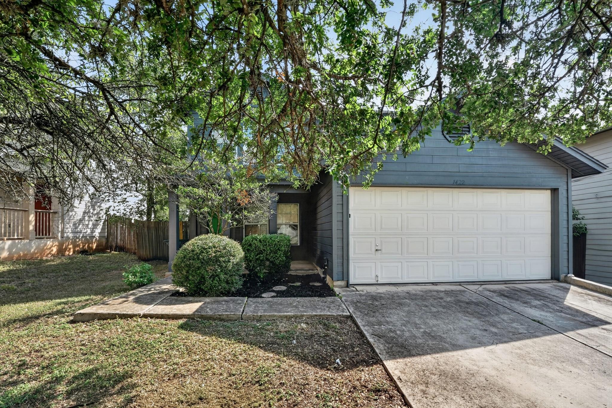 A classic facade with a panel garage door and lus