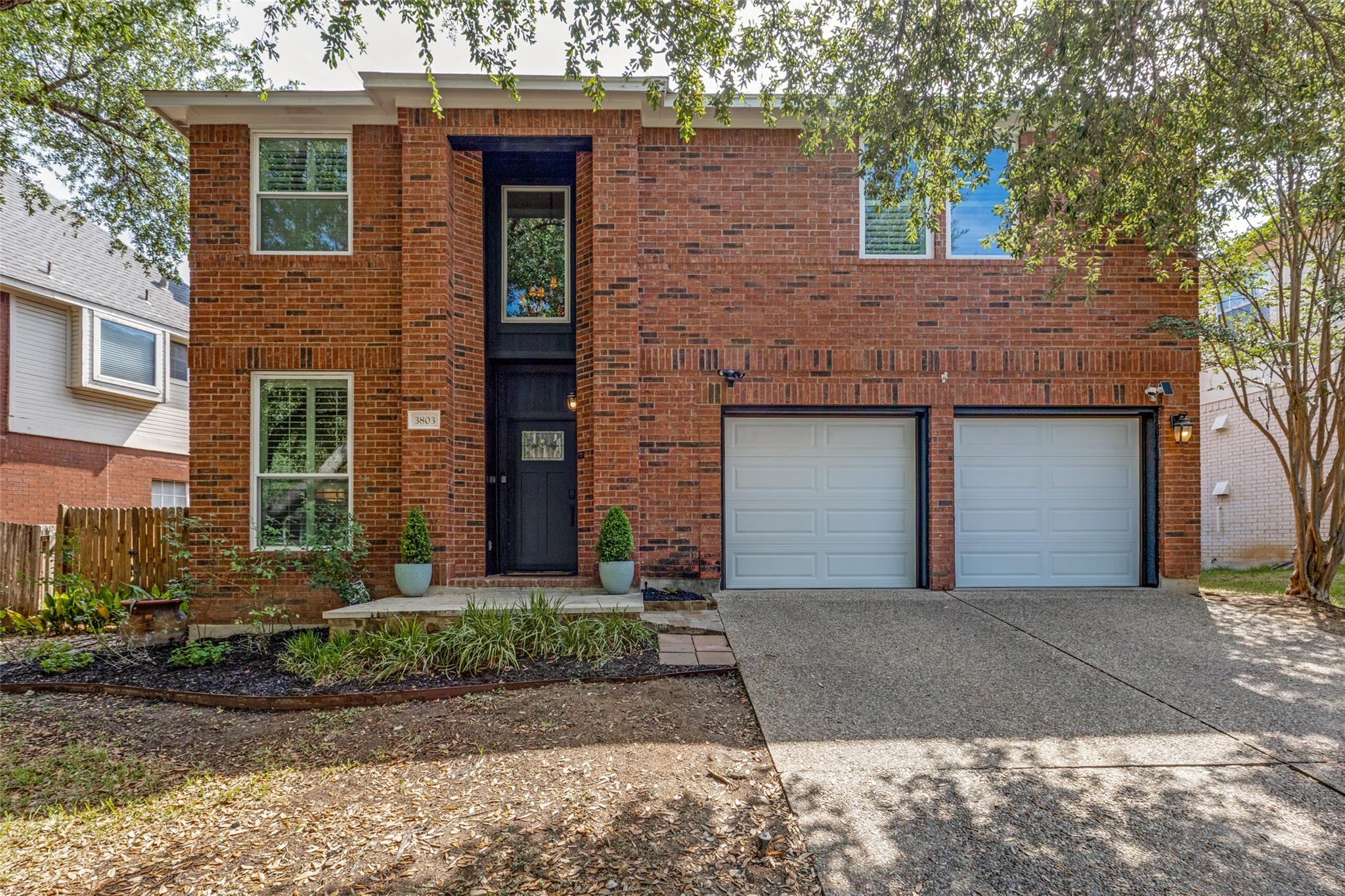 A classic brick exterior pairs with a double gara